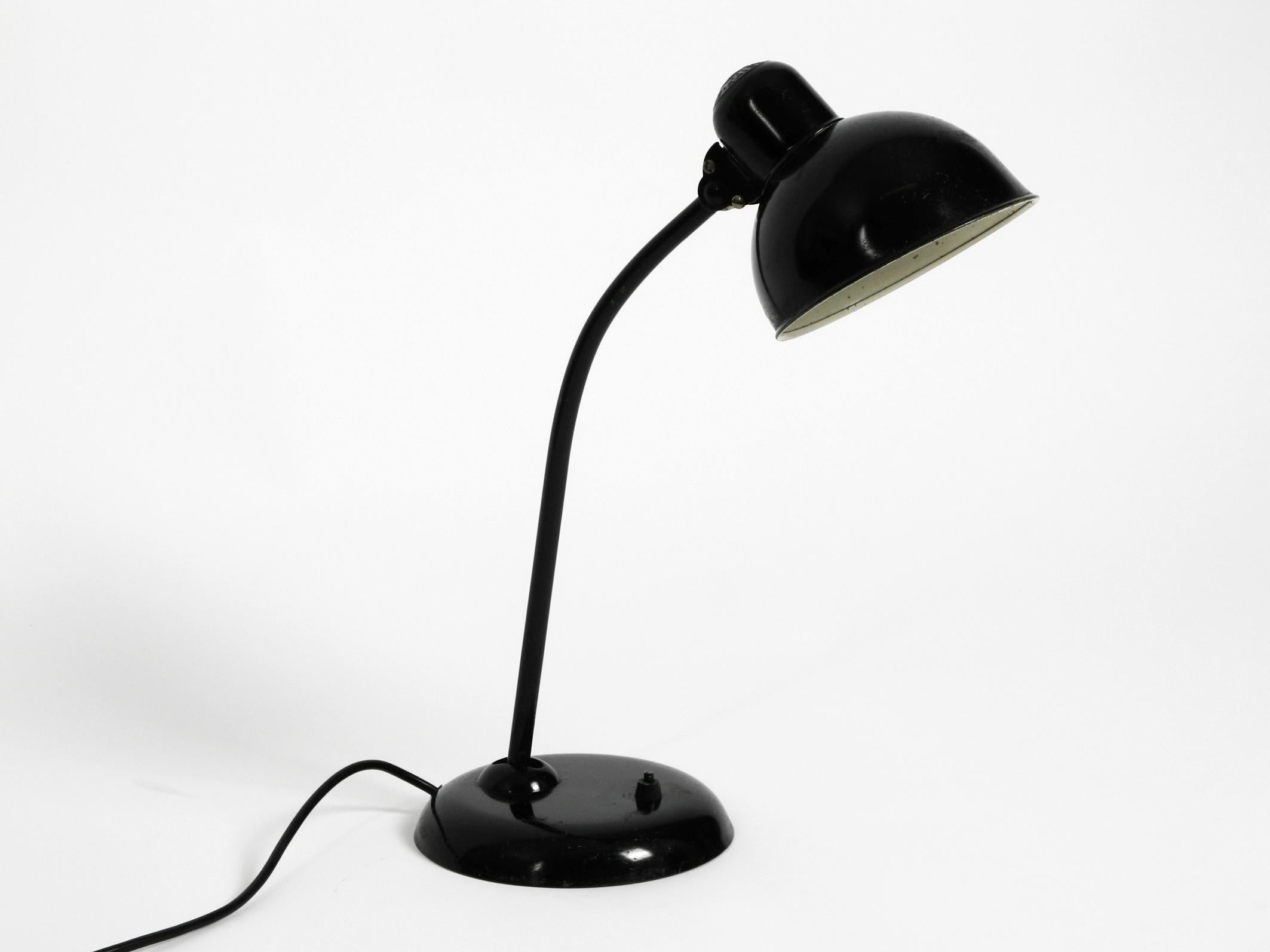 Original 1940s Kaiser Idell industrial modernist metal table lamp model 6551 in black.
100% original condition and fully functional. With original paint.
Great industrial design in very good vintage condition with a beautiful patina.
One E27