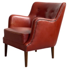 Original 1940s danish modern easy chair in patinated leather with brass nails.