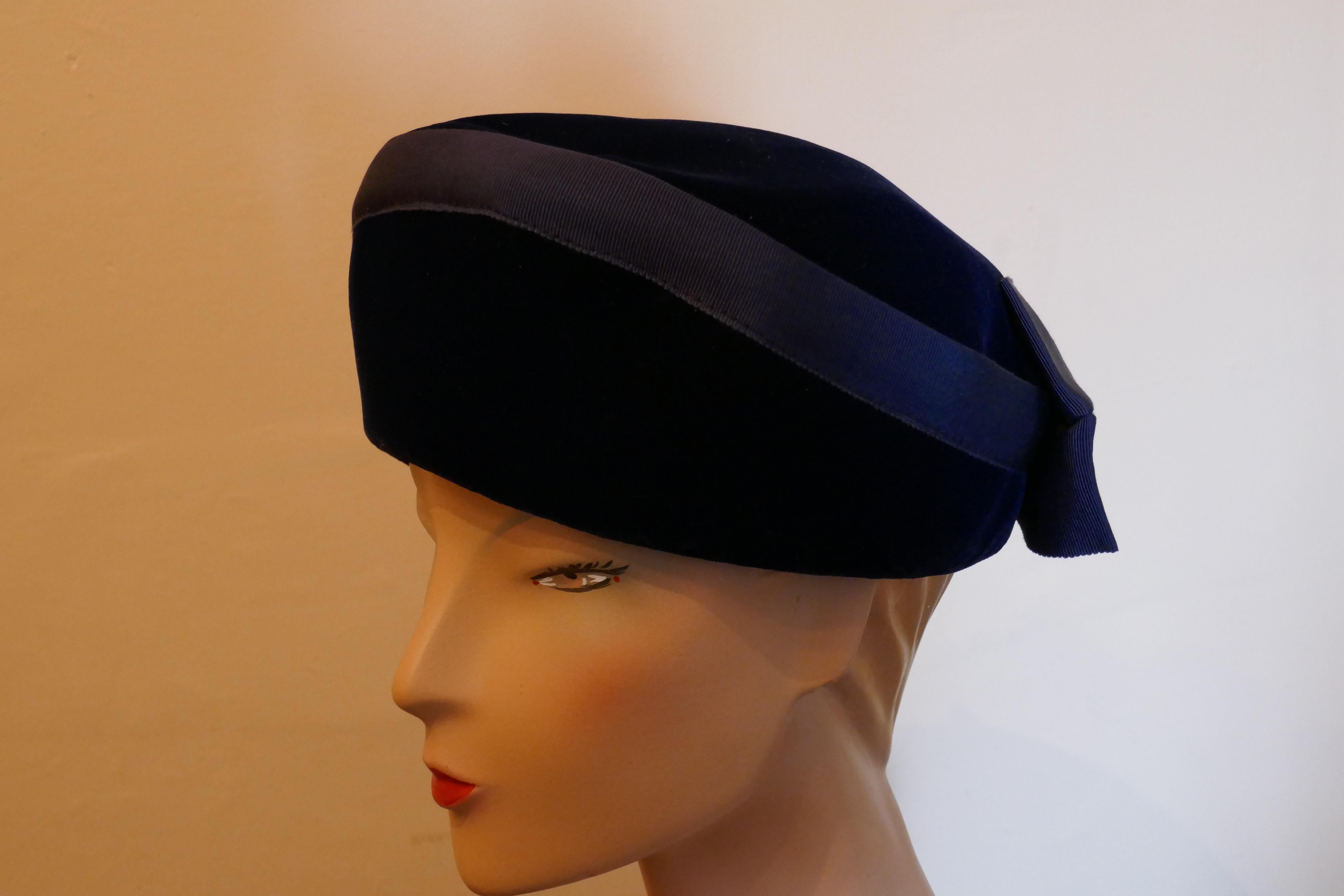 Original 1950s Deep Blue Plush Velvet Pill Box Hat

Stunning classic pill box hat, in plush velvet, trimmed with a Bow at the back
The Hat is in good condition, satin lined and measures 57cm around the band
The hat is top quality and will come