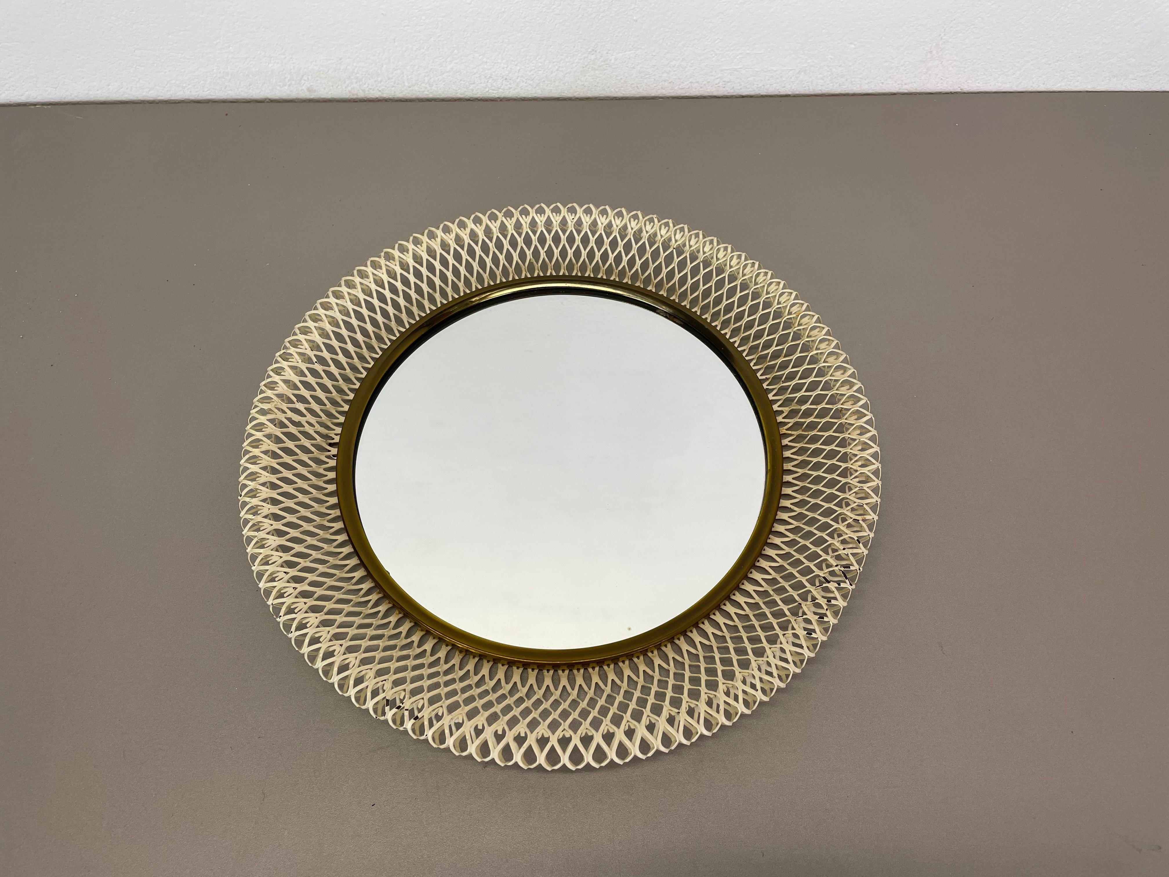 Article:

Wall mirror

Origin:

France

Design:

Remembers in design of Mategot

Age: 

1950s

This original vintage wall mirror was produced in the 1950s in France. it is made of solid metal with a metal grid perforation in white