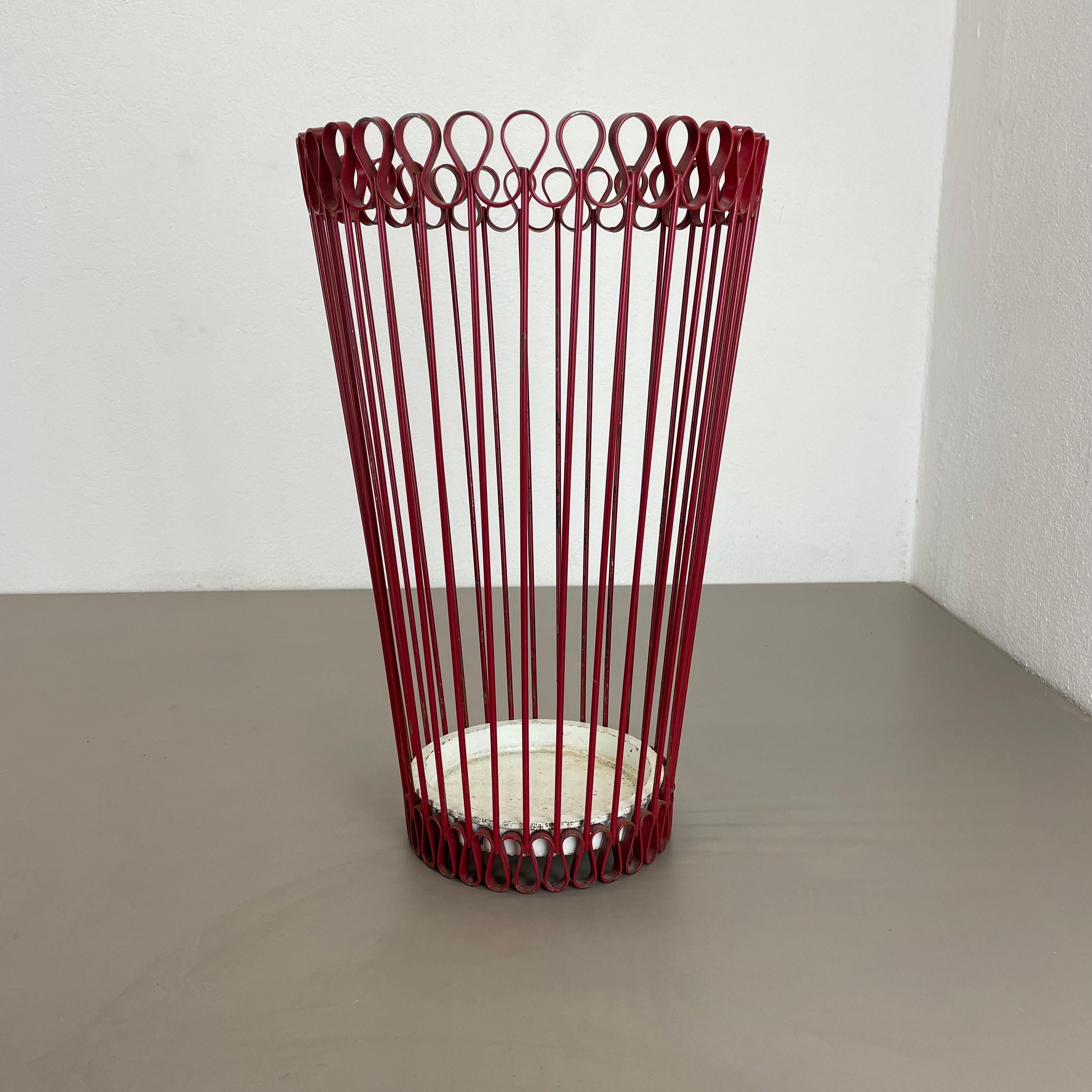 Article:

Umbrella stand in style of Matégot



Origin:

France


Age:

1950s



This original vintage umbrella stand element was produced in the 1950s in France. It is made of solid metal in a red lacquered tone, reminiscent with