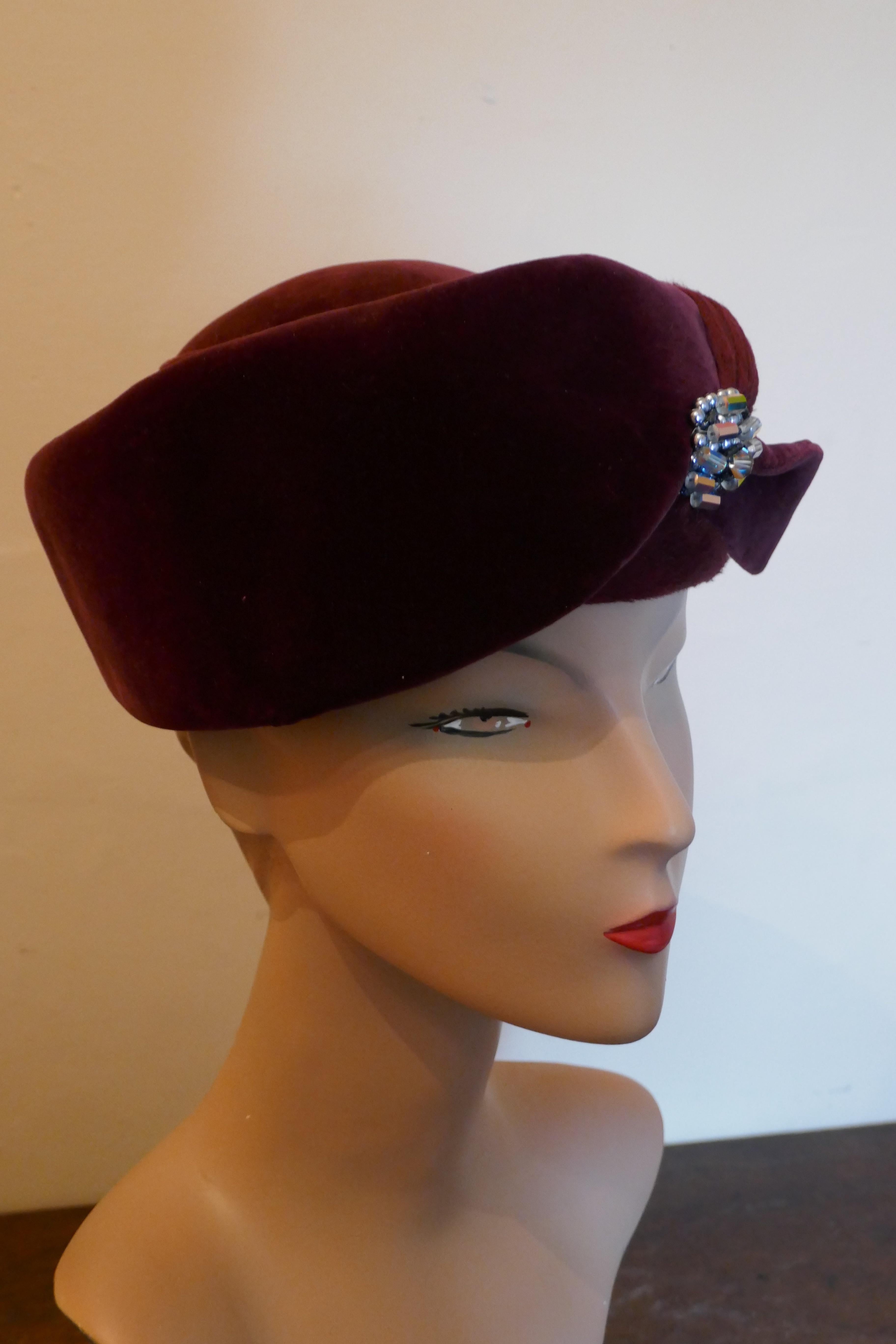 Original 1950s Maroon Felt and Velvet Hat BY Connor

This gorgeous Nostalgic Hat has beautiful slightly turban shape trimmed with a crystal broached the front 
This one is a classic design by Connor, wear it anywhere 
The hat is in good condition,