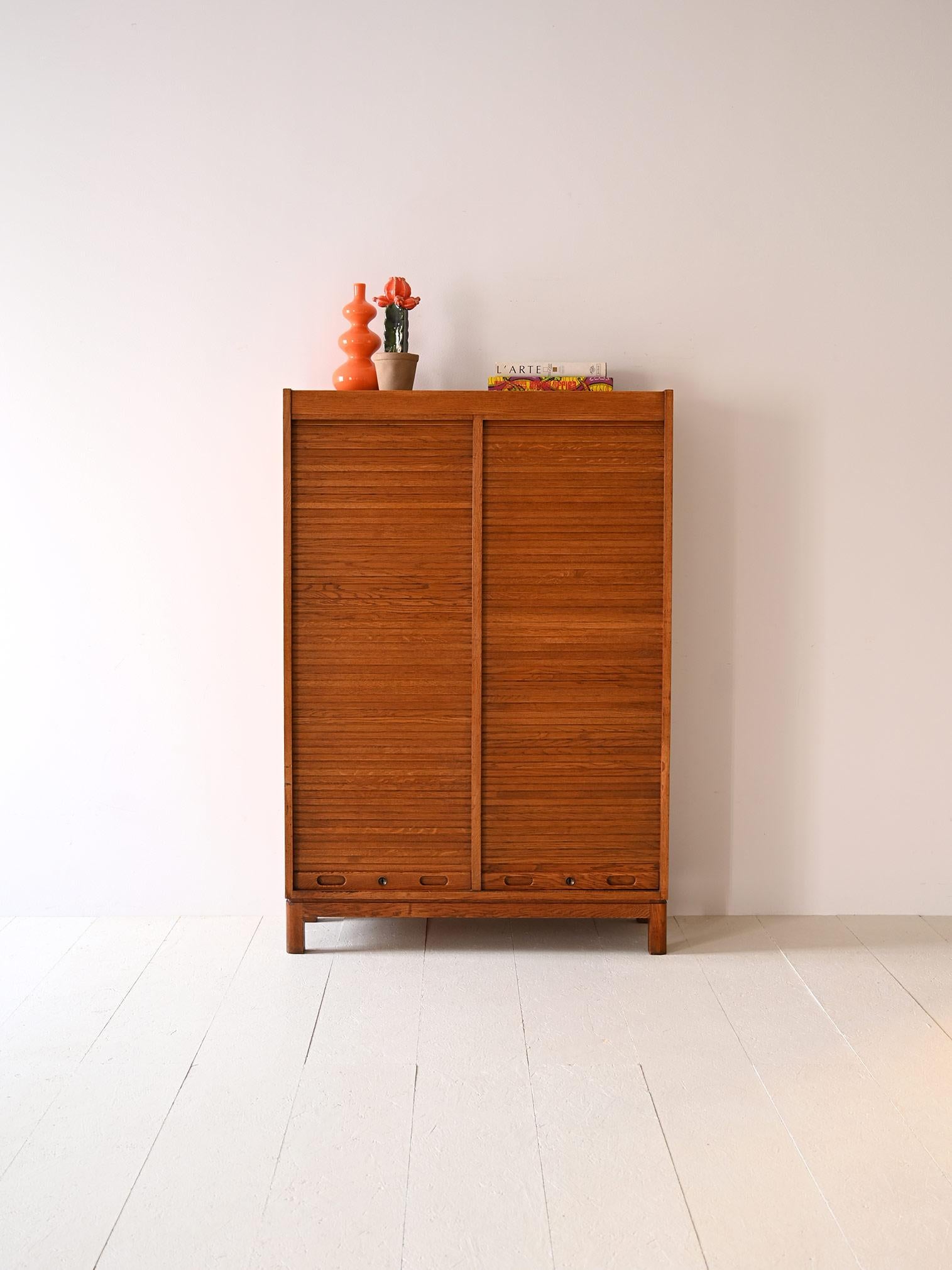 Original Scandinavian filing cabinet with drawers.
 
This beautiful office cabinet is distinguished by the presence of two shutter doors concealing the drawers.
The oak wood frame makes it a solid and durable piece that is also well suited for use