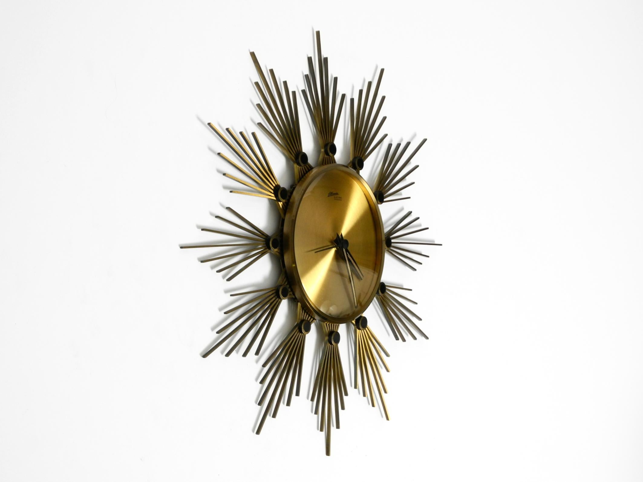 Mid-Century Modern Original 1950s Sunburst wall clock by Atlanta made of brass and battery operated For Sale