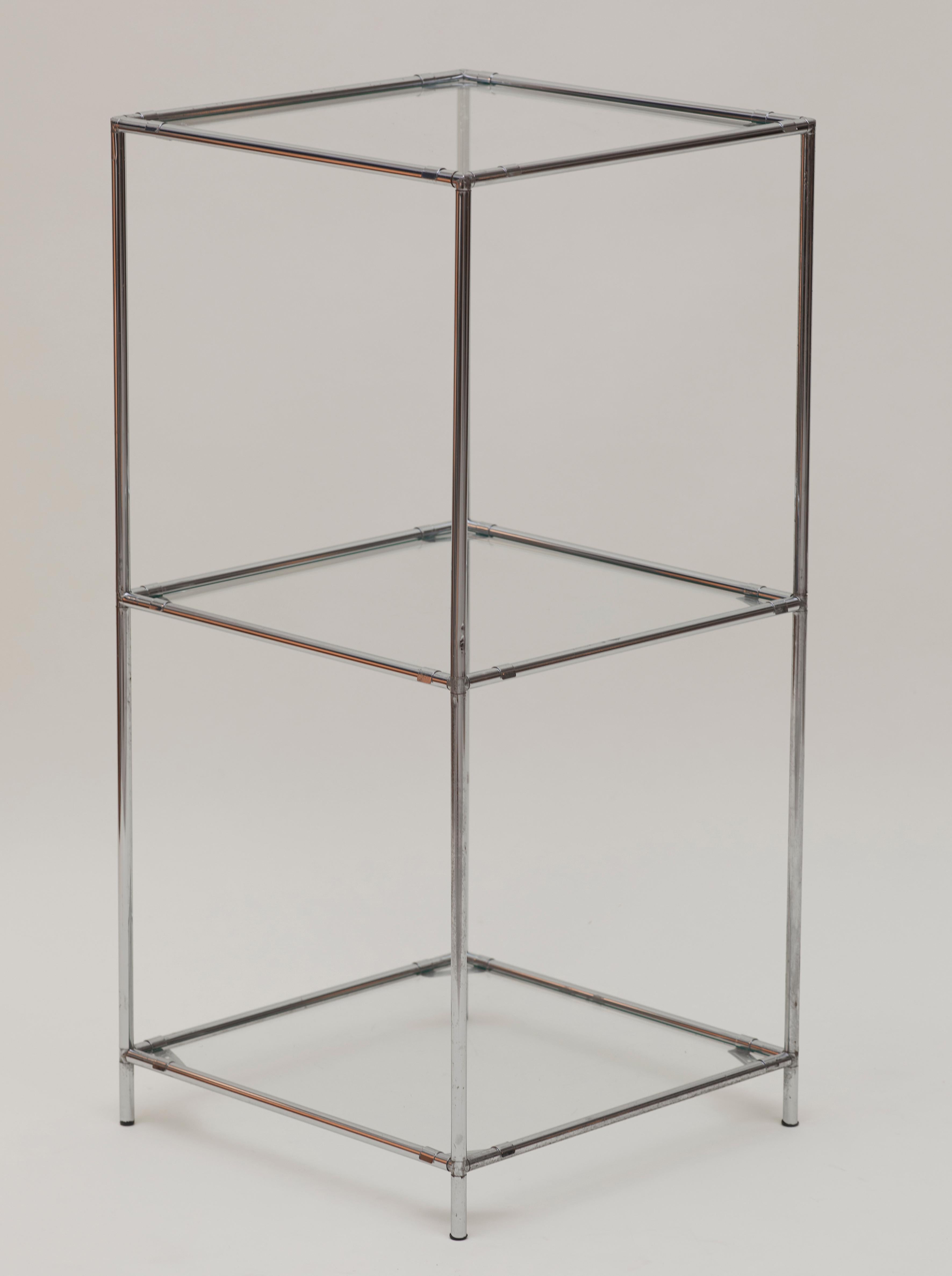 Original Poul Cadovius “Abstracta” modular bookcase (not the re-edition). Designed for Royal System, England c. 1960.

Features an elegant chromed tubular structure and glass shelves.

Wide enough for 12 inches records, plants, or art books.

Very