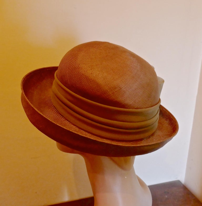 Original 1960s Copper Coloured Panama Style Hat, trimmed with Chiffon

This gorgeous Hat is very light and made with fine shiny stiffened straw, it has a beautiful copper tone with a pleated band and bow  

This one is an exquisite design wear it