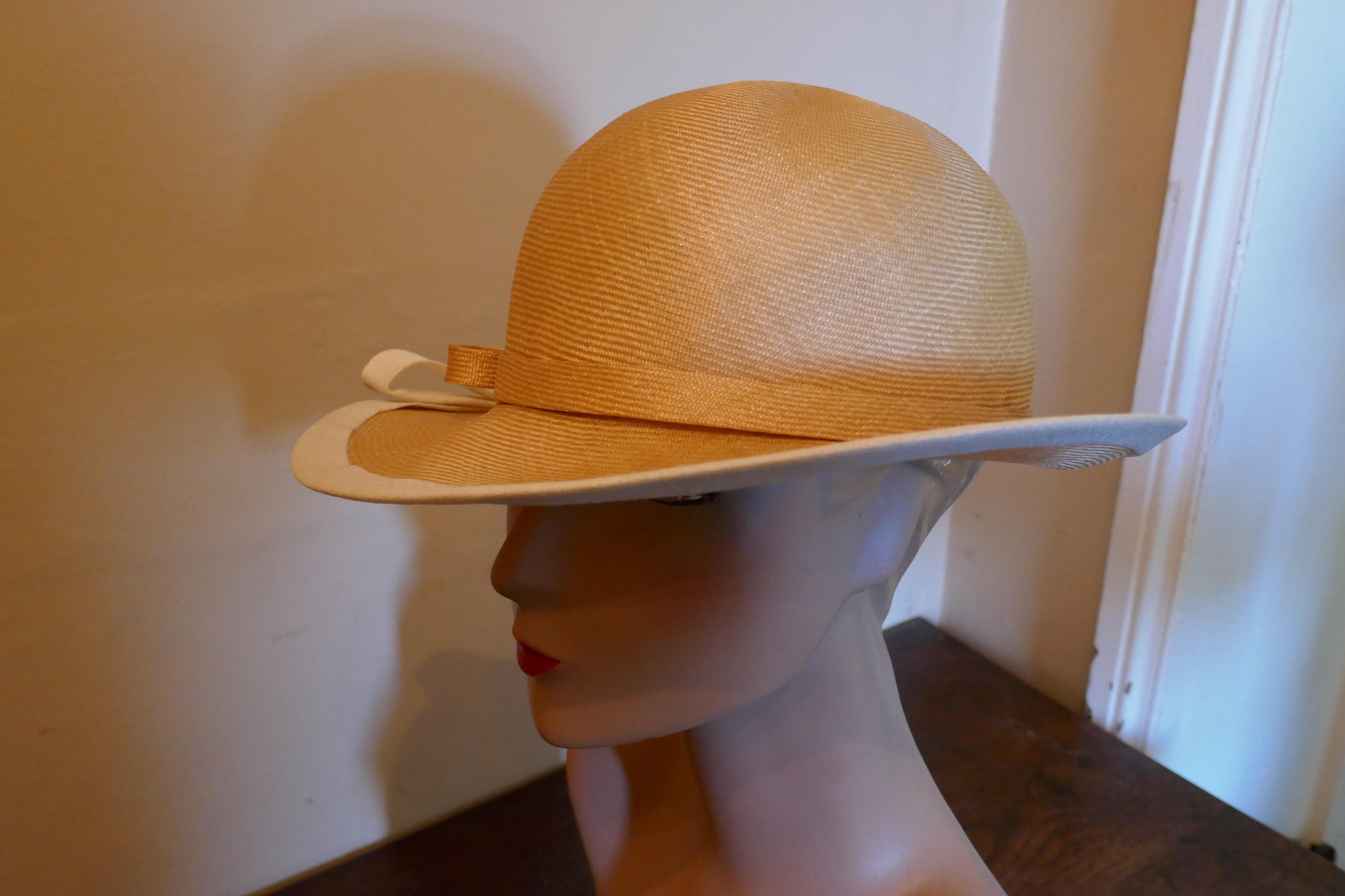 Original 1960s Designer Panama Style Hat, by Edna Wallace

This gorgeous Hat is very light and made with fine shiny stiffened straw, it has matching hat band and a white trim to the brim both with bows

This one is an exquisite design wear it