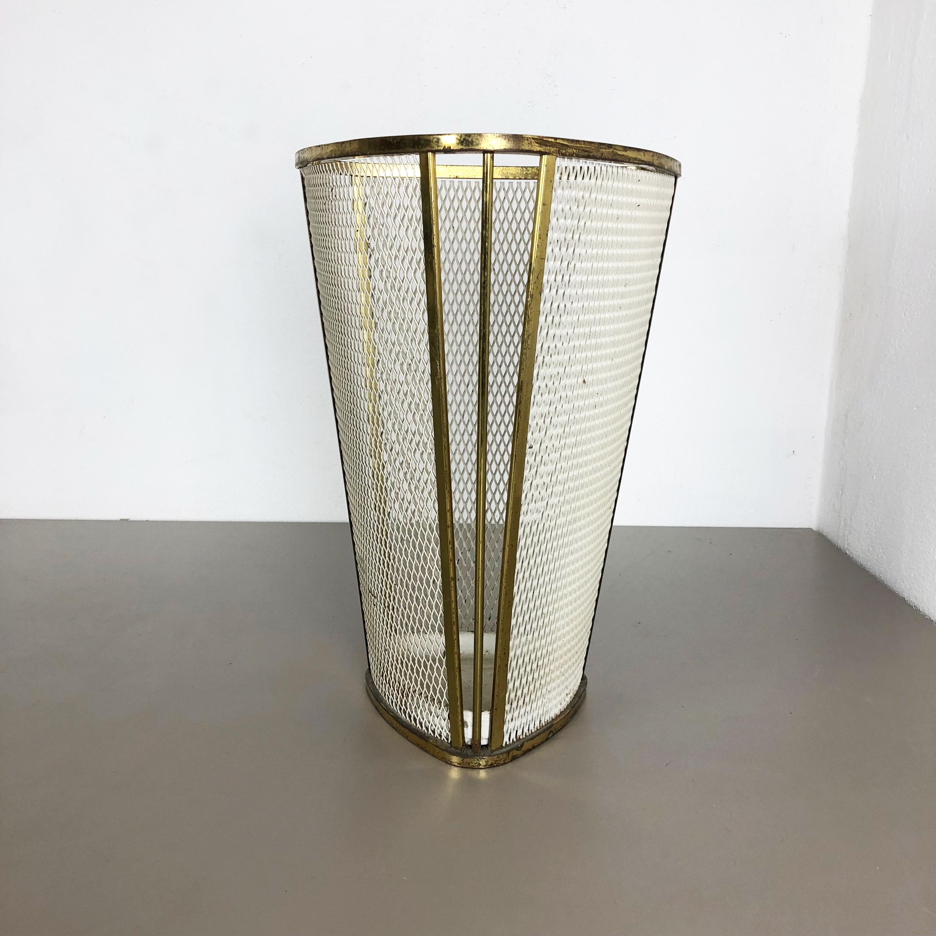 Article:

Umbrella stand in style of mategot



Origin:

France


Age:

1950s



Description:

this original vintage umbrella Stand was produced in the 1950s in France. it is made of solid metal in white lacquered tone with nice