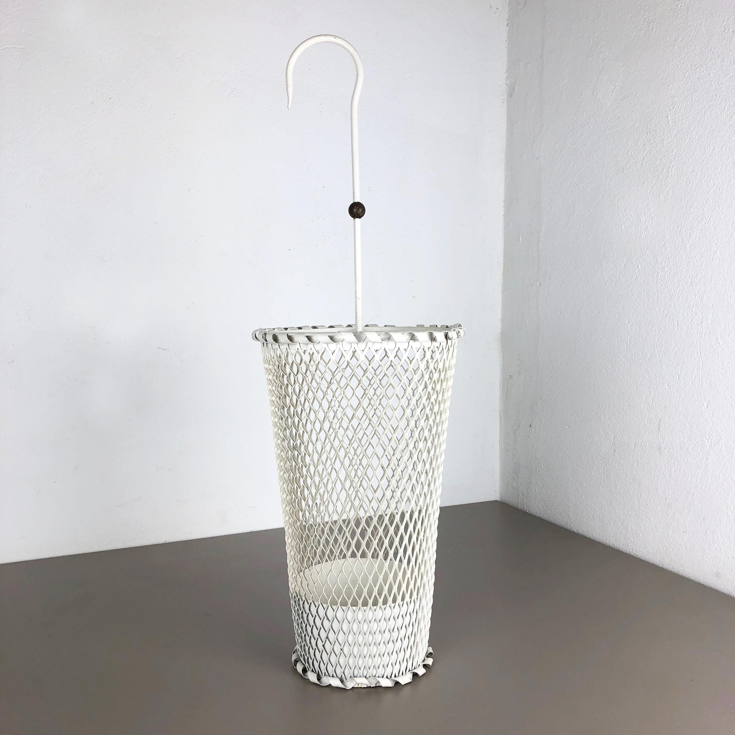 Article:

Umbrella stand in style of Matégot



Origin:

France


Age:

1950s





This original vintage umbrella stand was produced in the 1950s in France. It is made of solid metal in white lacquered tone. At the top this