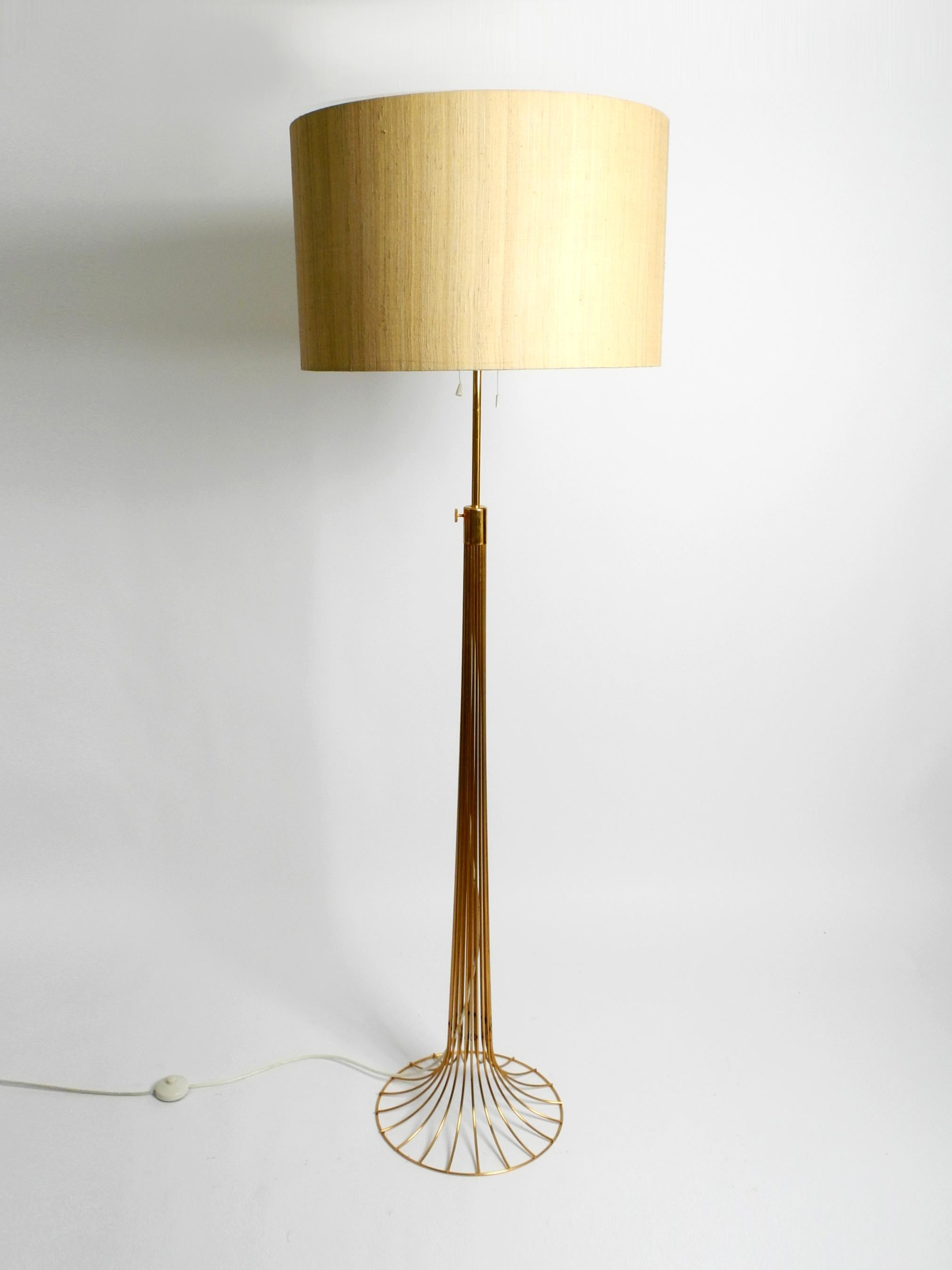 Very rare beautiful original 1960s large metal wire floor lamp.
Great very elegant Space Age design. Made in Germany.
The frame is anodized in gold color and steplessly height-adjustable.
The screw for fixing is just below the bulbs. See photo