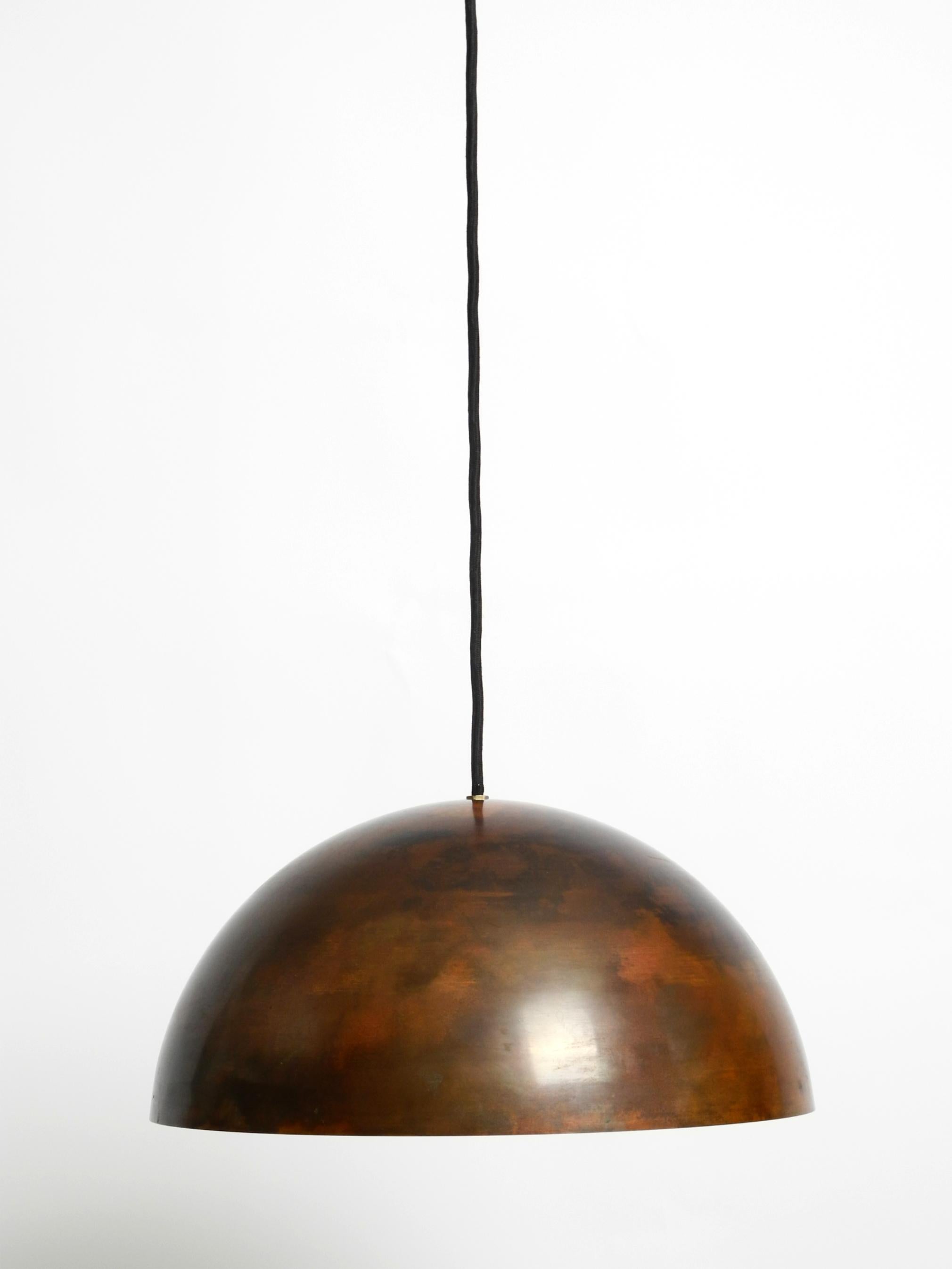 Very elegant, rare, original 1960s pendant lamp with a solid beautiful patinated copper shade.
Inside with a screw-on white metal reflector.
Great Space Age design from the 1960s. Manufacturer is Beisl Leuchten. Made in Germany.
With original label