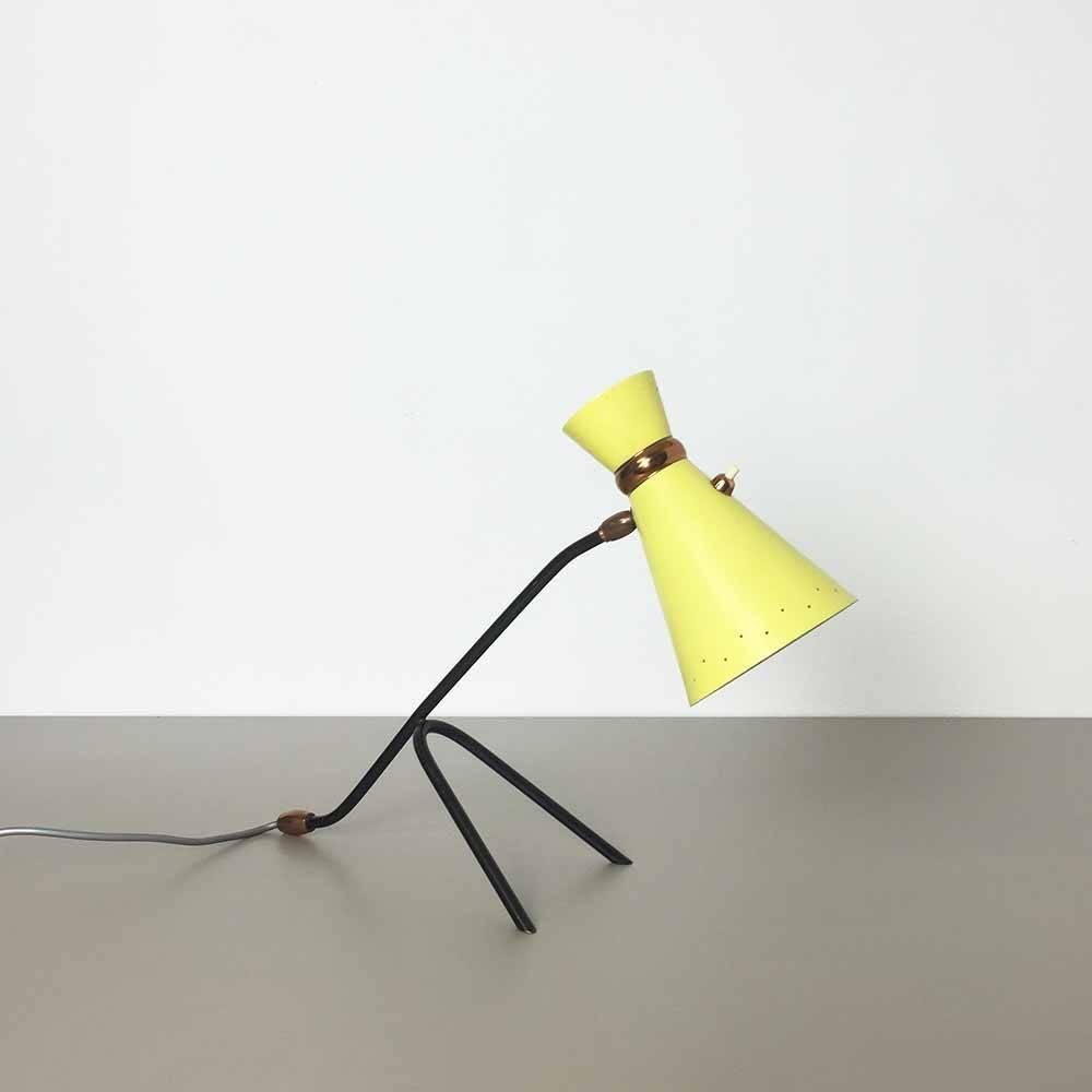 1960s desktop light.

Origin Italy,

in style of Stilnovo,

1960s.

Rare 1960s table light, made of high quality metal, in black and yellow, lovely formed shade on a minimalistic black metal base. Origin of the light is Italy and its