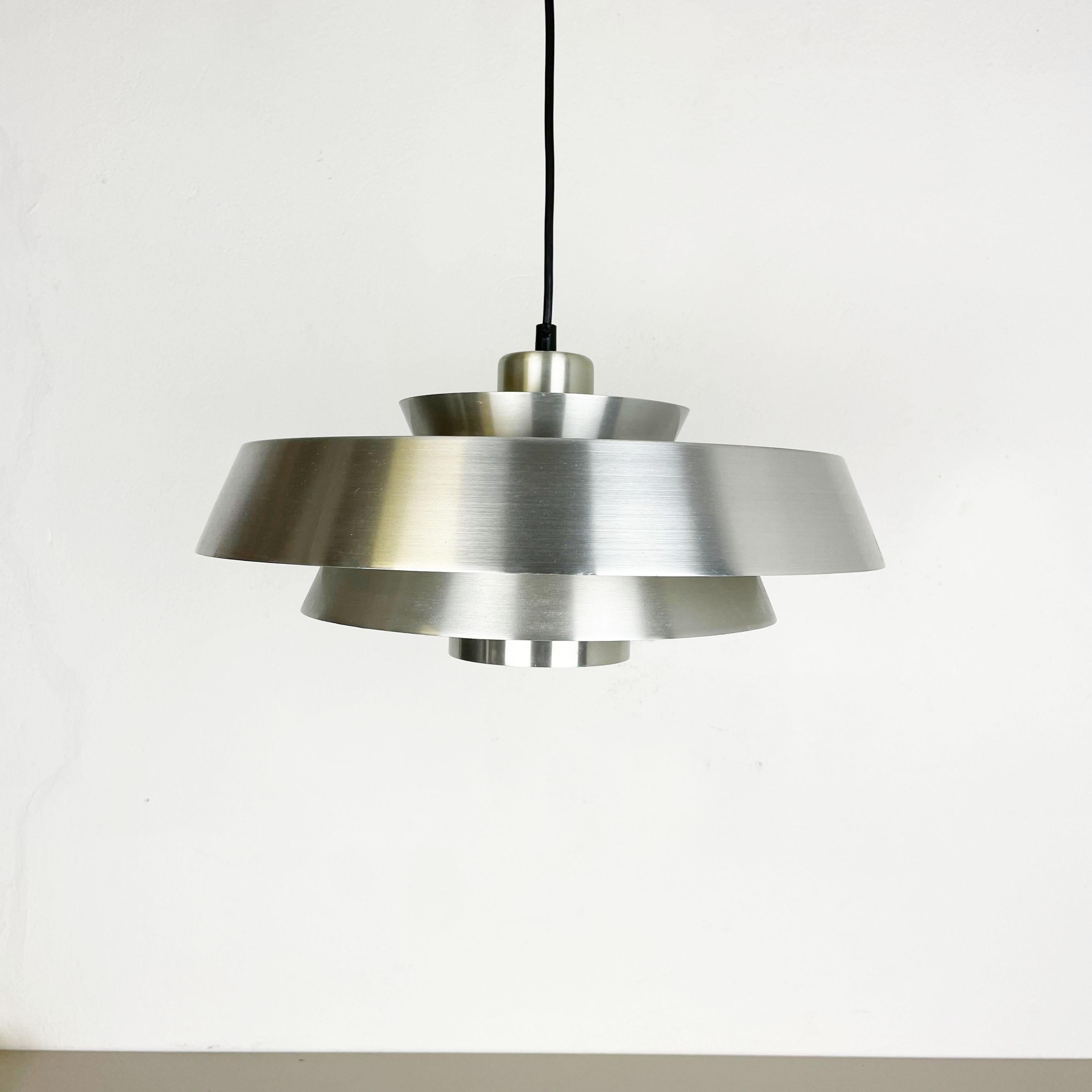 Aluminium hanging light,

designed by Jo Hammerborg, 1963,

produced by Fog & Mørup, Denmark.

This Mid-Century pendant light, model 'NOVA,' was designed by Jo Hammerborg for Fog & Mørup in the 1960s in Denmark. The metal shade of this light