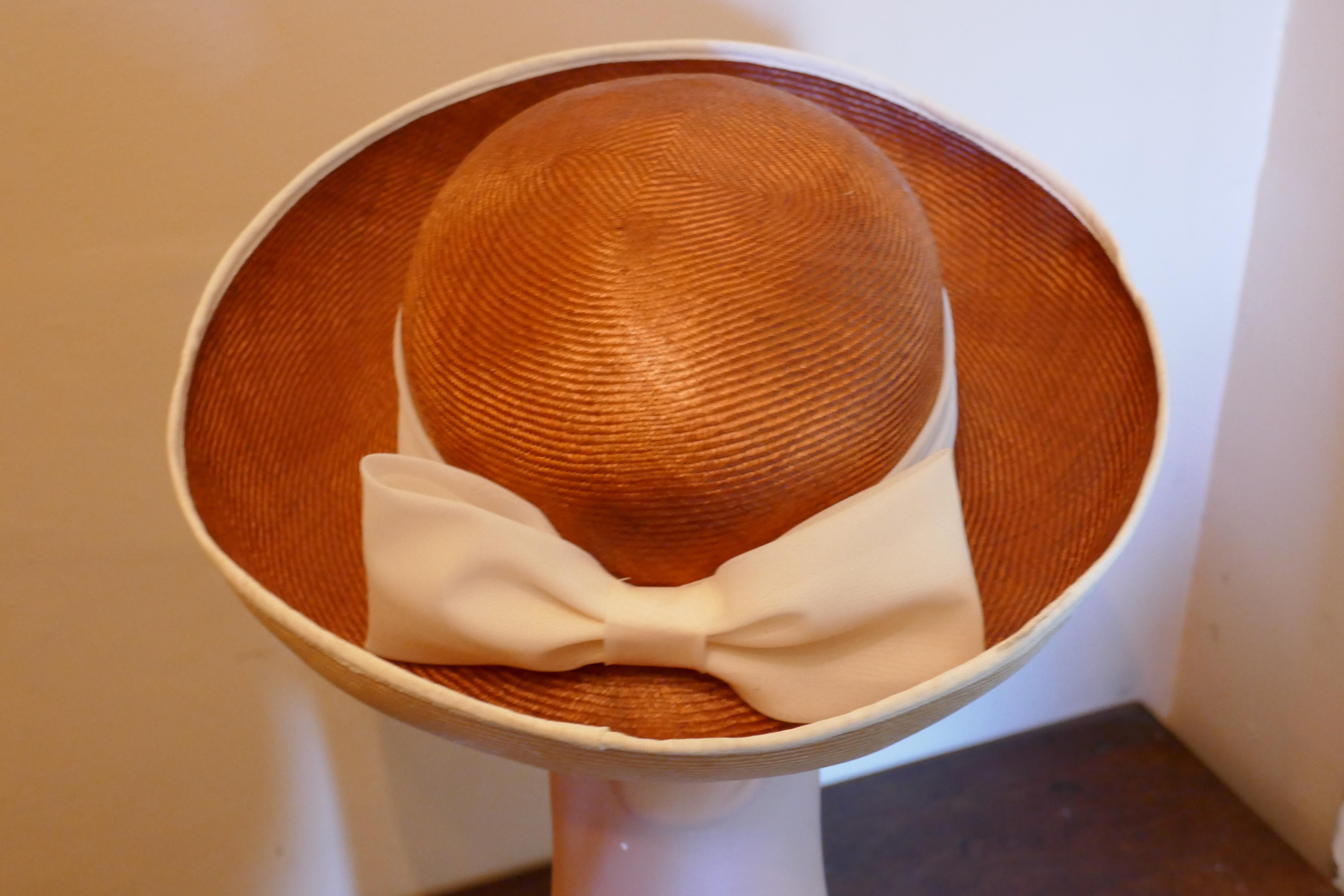 Original 1960s Panama Hat trimmed with Chiffon Ribbon by James Egleton

This is a very elegant hat, it is made in 2 tone soft shiny straw fabric with wide upturned brim, the main colour is  a beautiful bronze and the underside of the brim is cream,