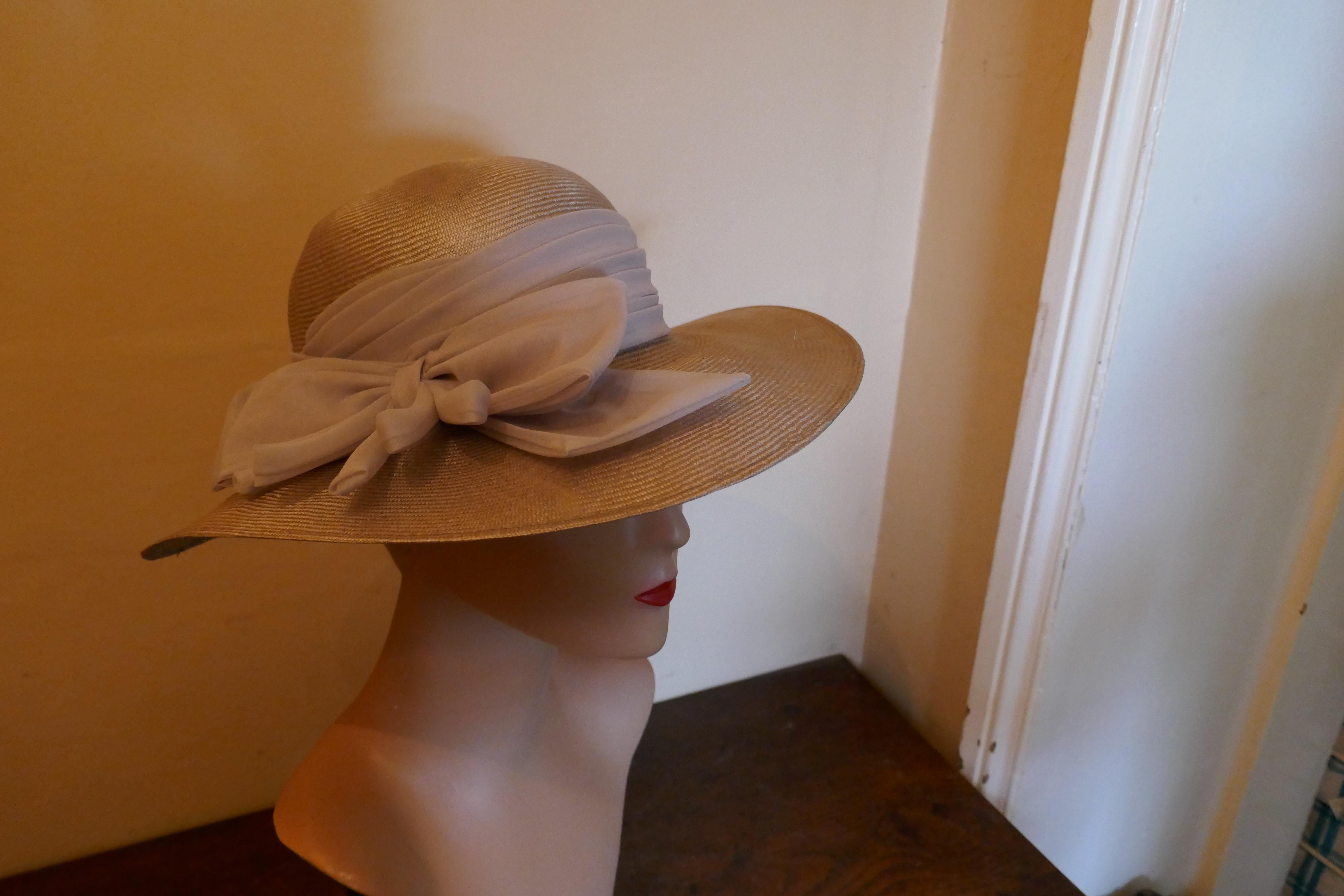 Original 1960s Straw Style Hat, Garden Party Chic

This gorgeous Hat is very light and made with fine shiny stiffened straw, it has beautiful pale lilac pleated band ties in a bow at the back 

This one is an exquisite design wear it anywhere and