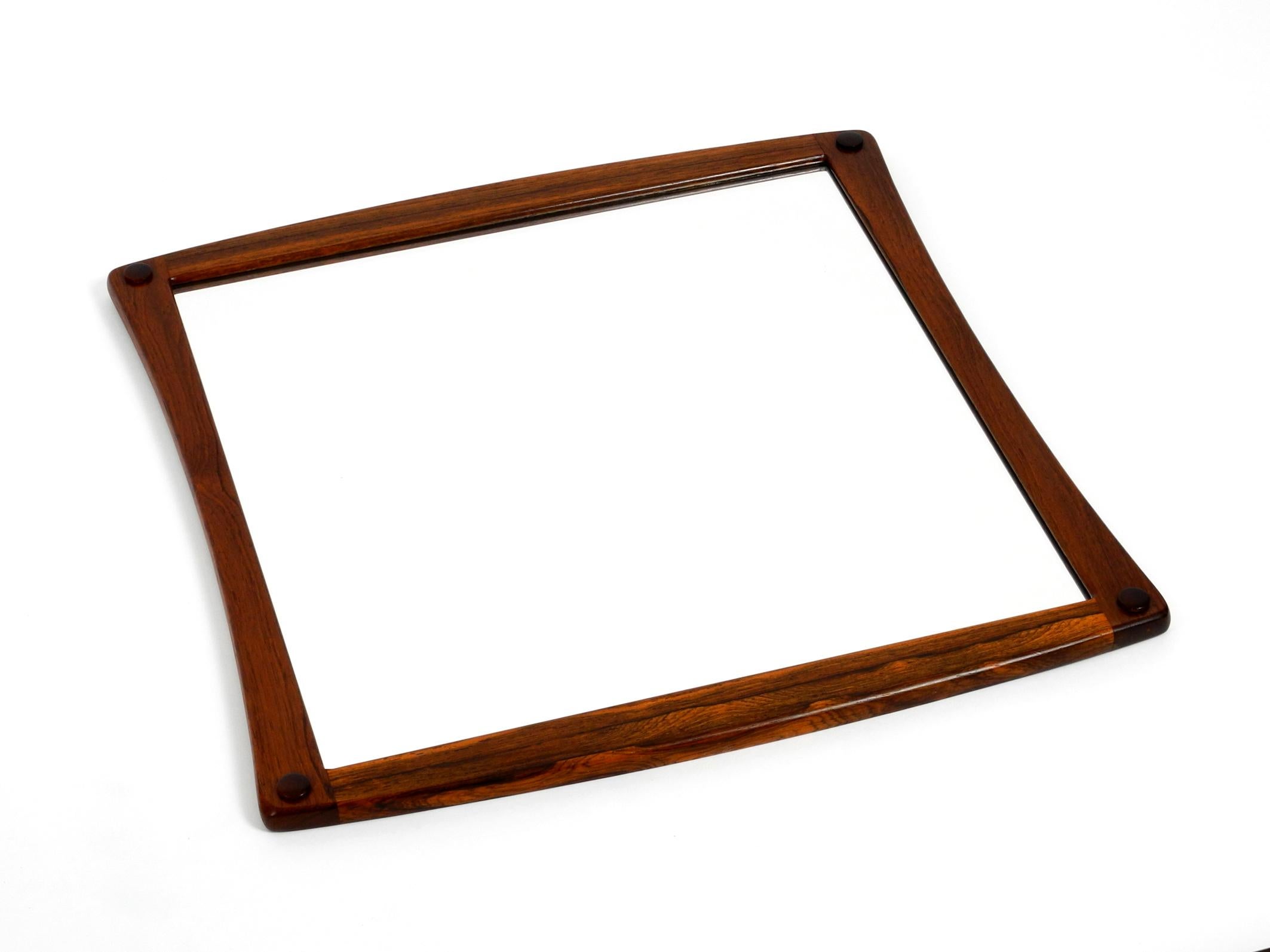 Original 1960s beautiful teak wall mirror in a rare shape.
Designed and manufactured by Aksel Kjersgaard.
All Kjersgaard products were made in the municipality of Odder in Denmark.
Very elaborately manufactured wall mirror made of solid teak with