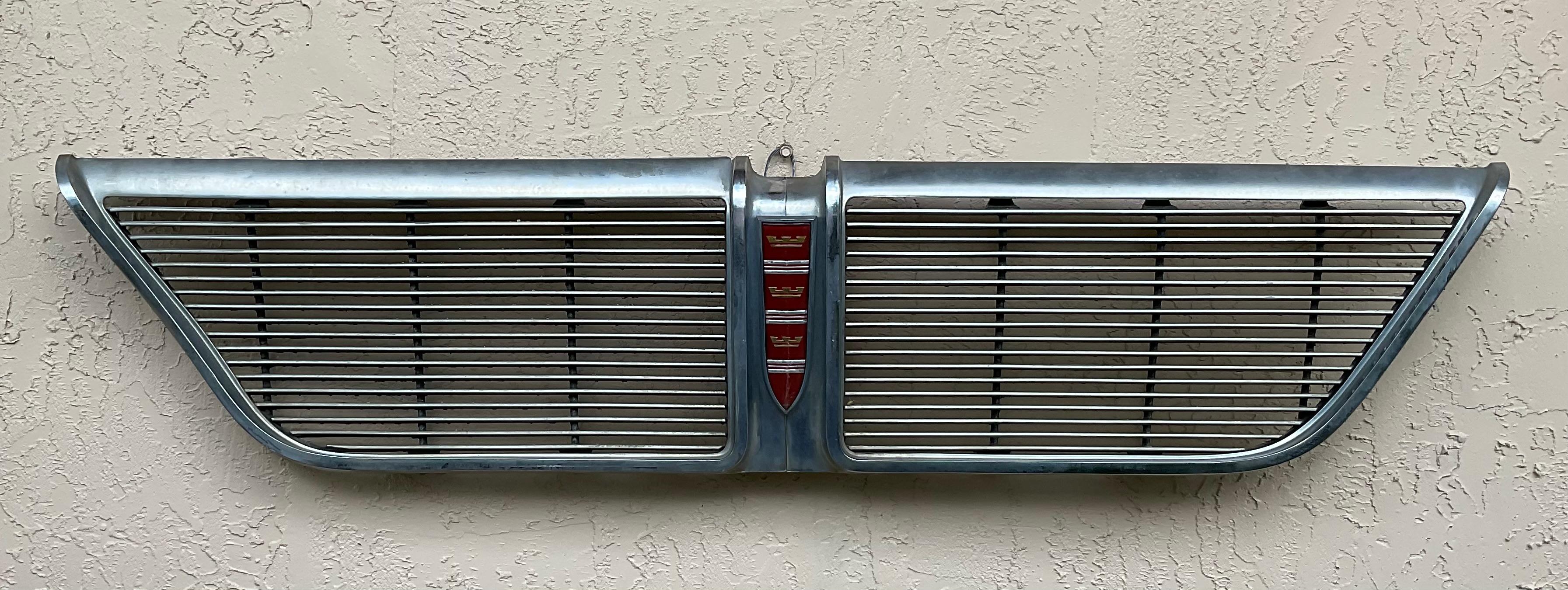 

This classic 1964 Chrysler New Yorker grill is a must-have for any collector of vintage American cars or Americana. this decorative piece will make a striking statement mounted on your wall. Its timeless design and chrome finish capture the