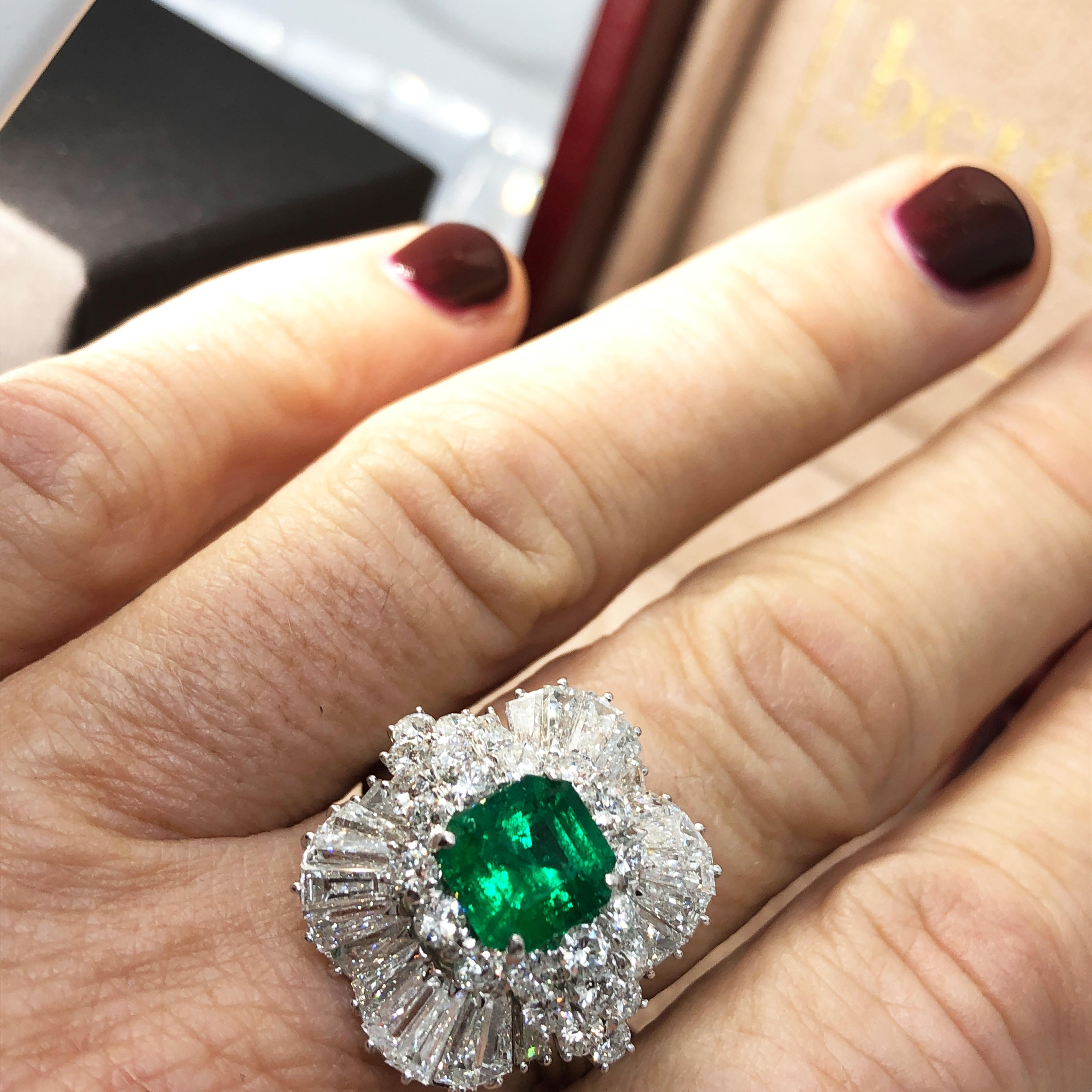 Outstanding, Original 1965, 1.41 Carat Muzo Emerald Unusual Asscher Cut Minor Oil, in a fabulous, handcrafted 3.36 Carat White Diamond (D, IF) Ballerina Ring Setting.
In our fitted burgundy leather case.
Detailed gemmological certificate