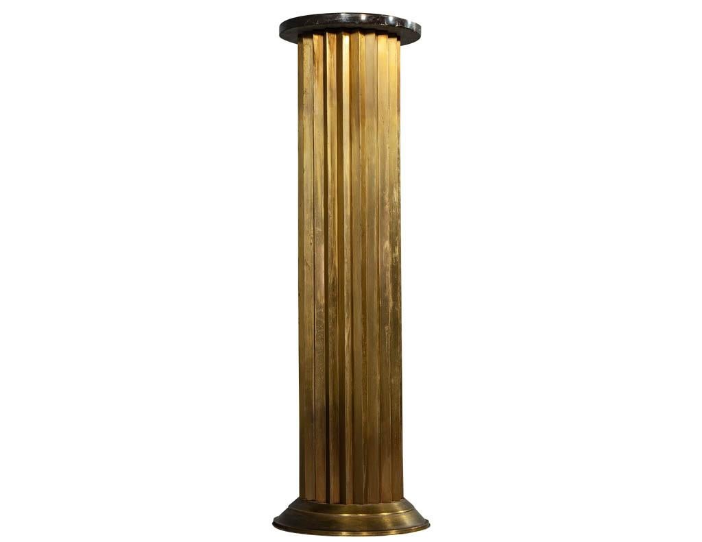 Original French Art Deco fluted brass pedestal column. Featuring unique fluted brass design and original round marble top. Price includes complimentary curb side delivery to the continental USA.