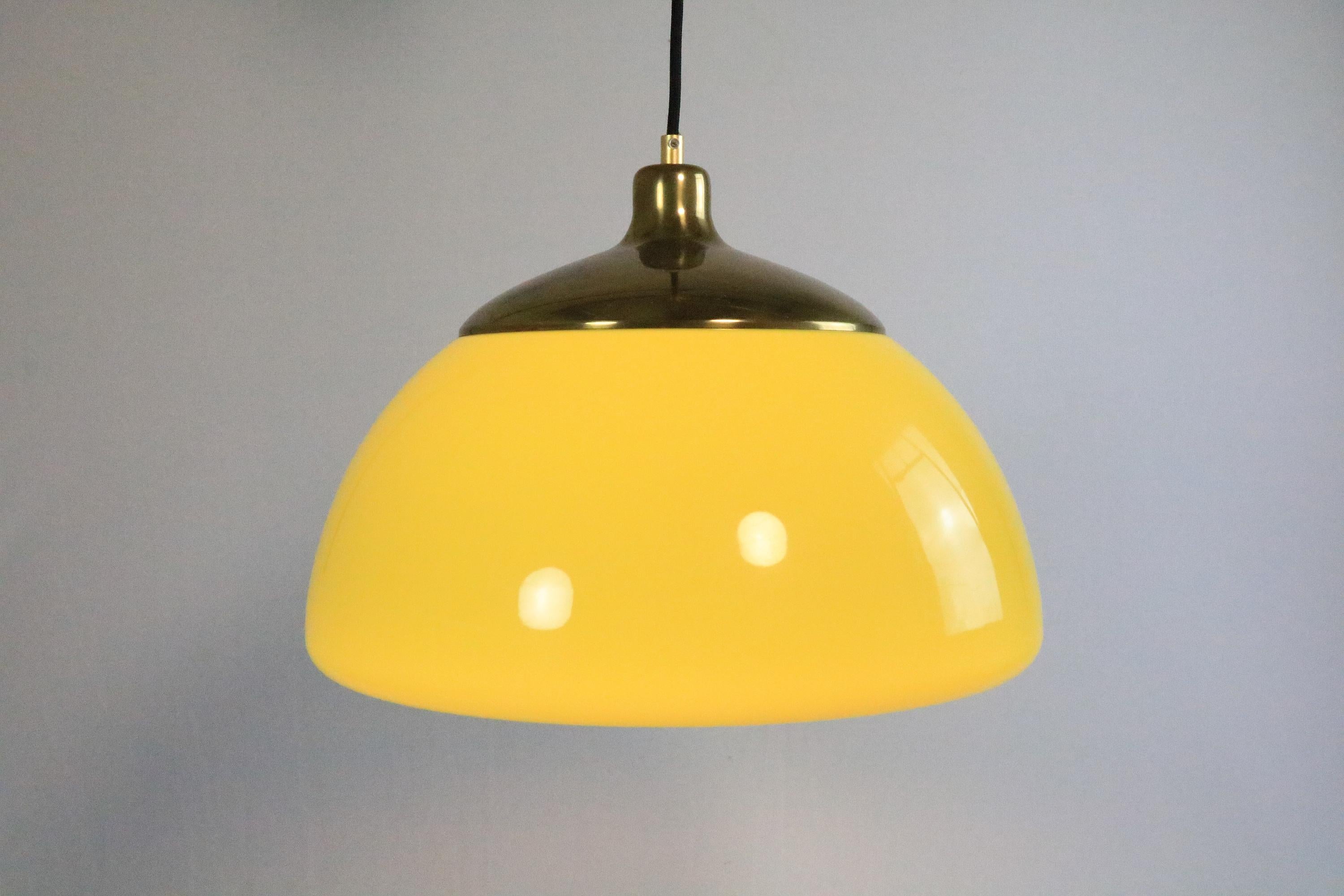 Beautiful Hanging Lamp by Cosack, Germany.

Very rare colour. The Yellow changes into a warmer tone, when the light is on.
The attractive color is complemented by the brass parts.

The former adjustable spirale cable was exchanged for a more