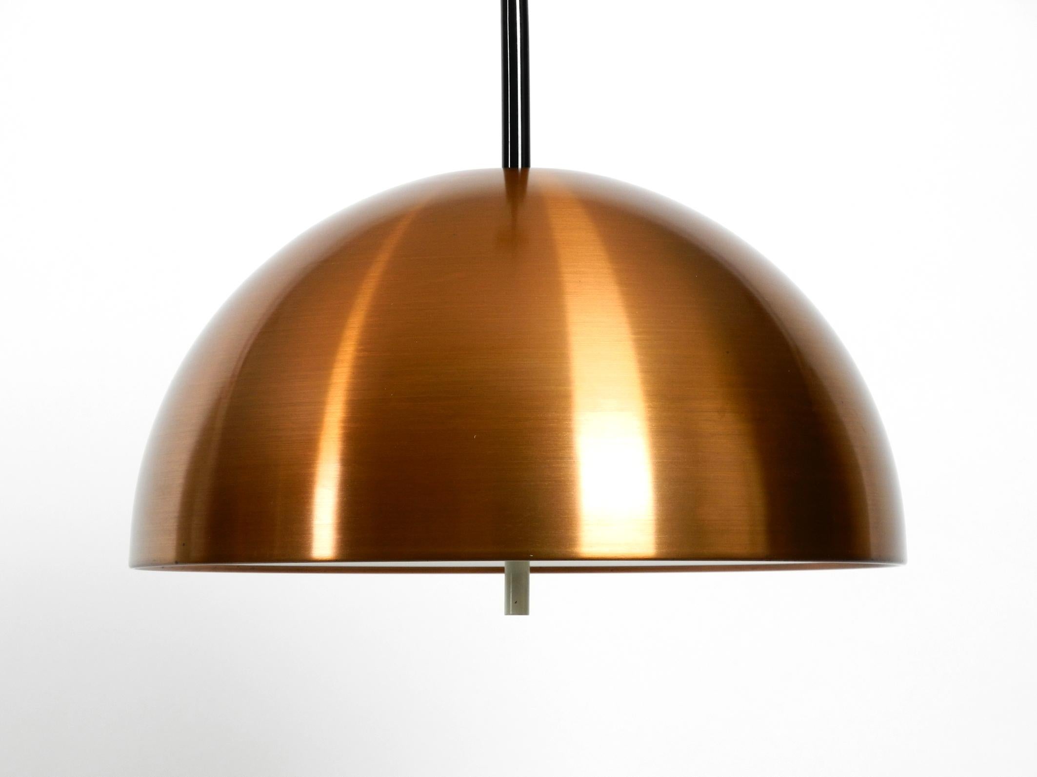 Very elegant, rare, large original 1970s Staff pendant lamp with a copper shade.
Great Space Age design from the 1970s.
Copper shade painted white inside and with a plastic cover for glare-free light.
Two original sockets for 100 watts