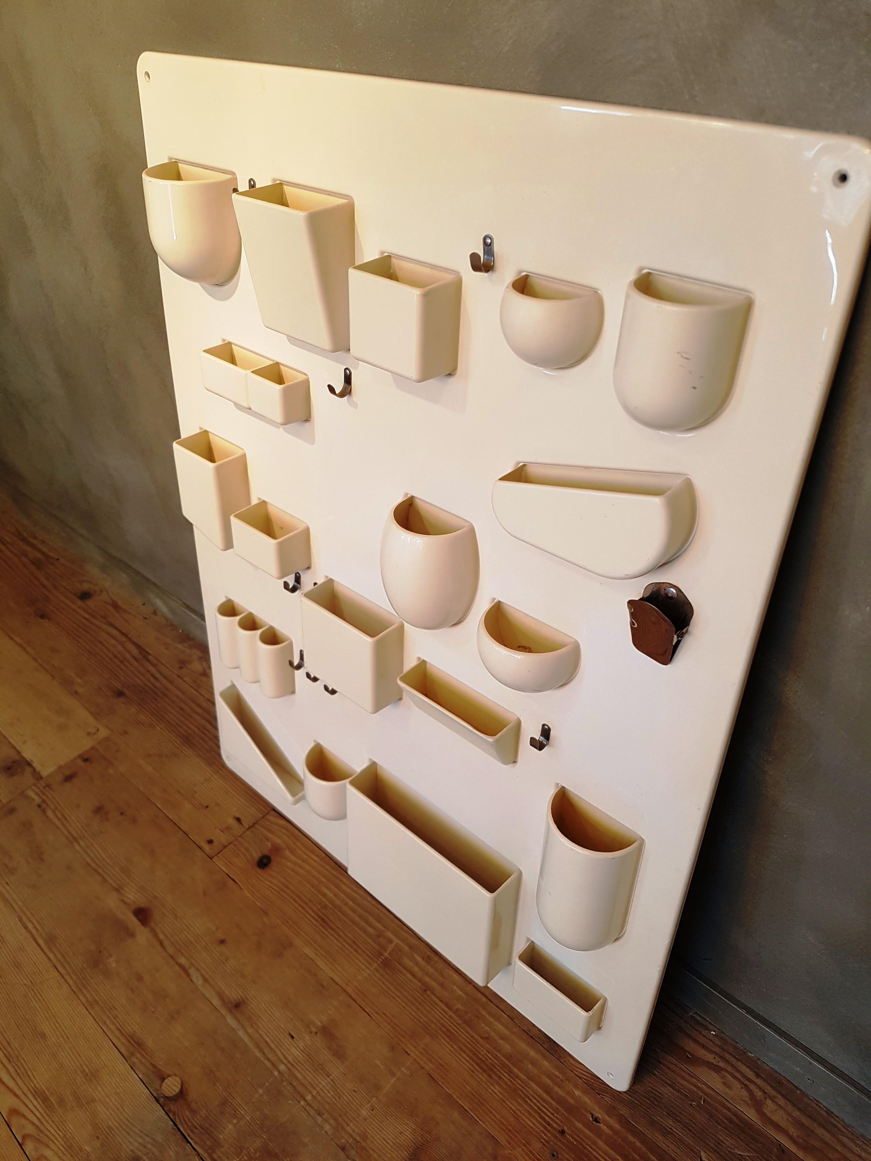 This pop art wall organizer is made from crème white ABS plastic. The object has several plastic compartments, as well as a chrome clip and several chrome hooks. In a very good condition with only a little rust on the metal hooks and clips, but