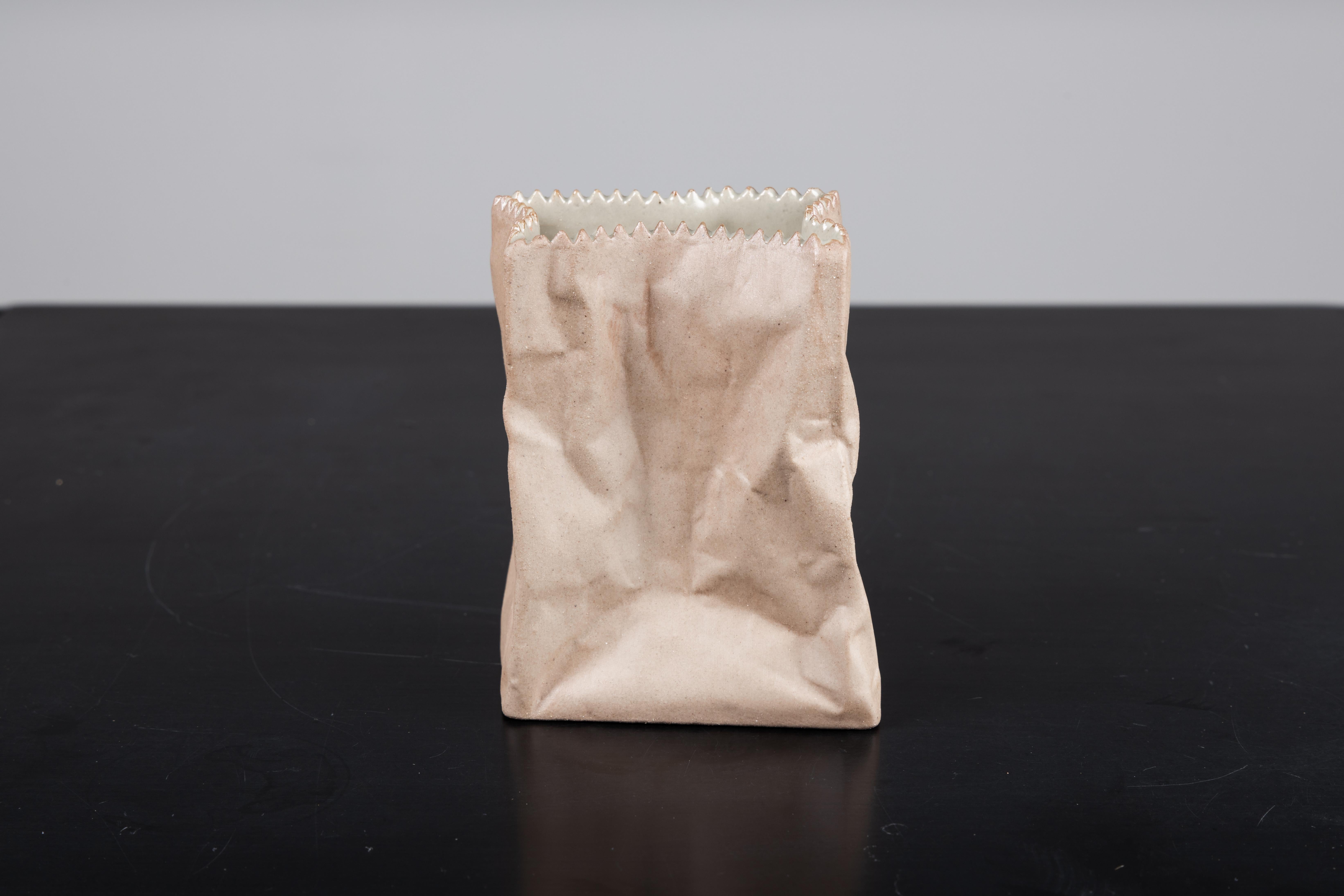 Paper or plastic or…Wirkkala’s fun and whimsical 1977 Pop Art take on tromp l’oeil, something that is not what it appears to be. Here, a used paper bag is actually a porcelain vase. Kraft paper brown with a serrated top edge. Perennially popular and