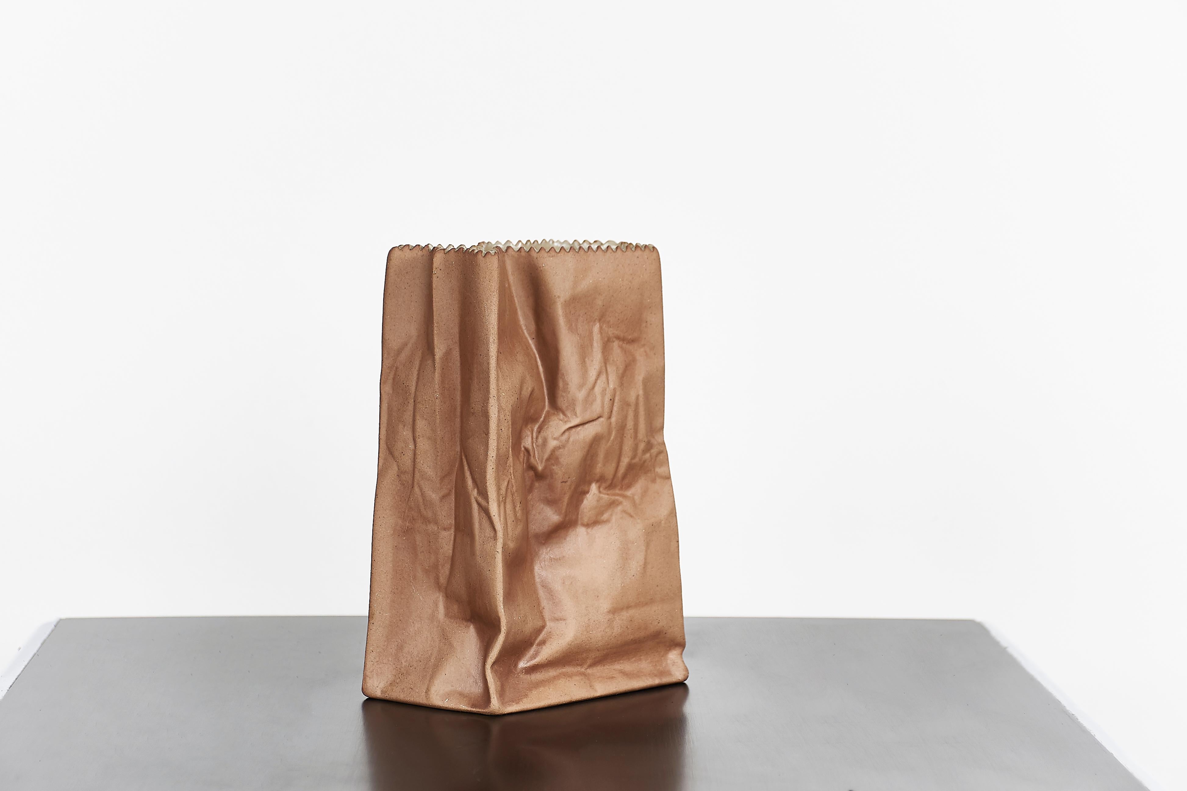 Paper or plastic or…Wirkkala’s fun and whimsical 1977 Pop Art take on tromp l’oeil, something that is not what it appears to be. Here, a used paper bag is actually a porcelain vase. Kraft paper brown with a serrated top edge. Perennially popular and