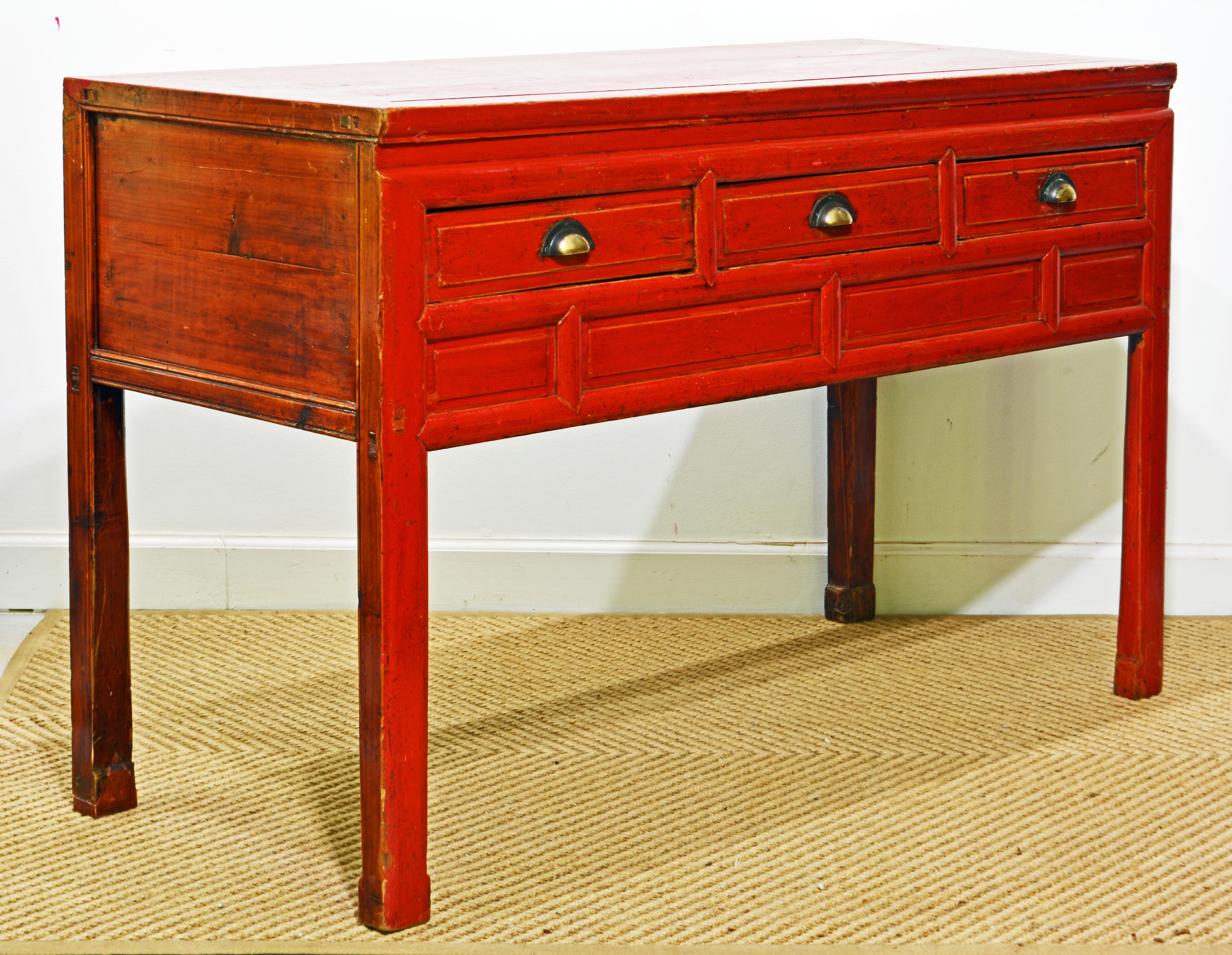 This is a rarely seen authentic 19th century Chinese console table with three drawers under which there is a storage compartment. The top and the front is red lacquered, the ends are natural wood lacquered. This piece of furniture is presented in