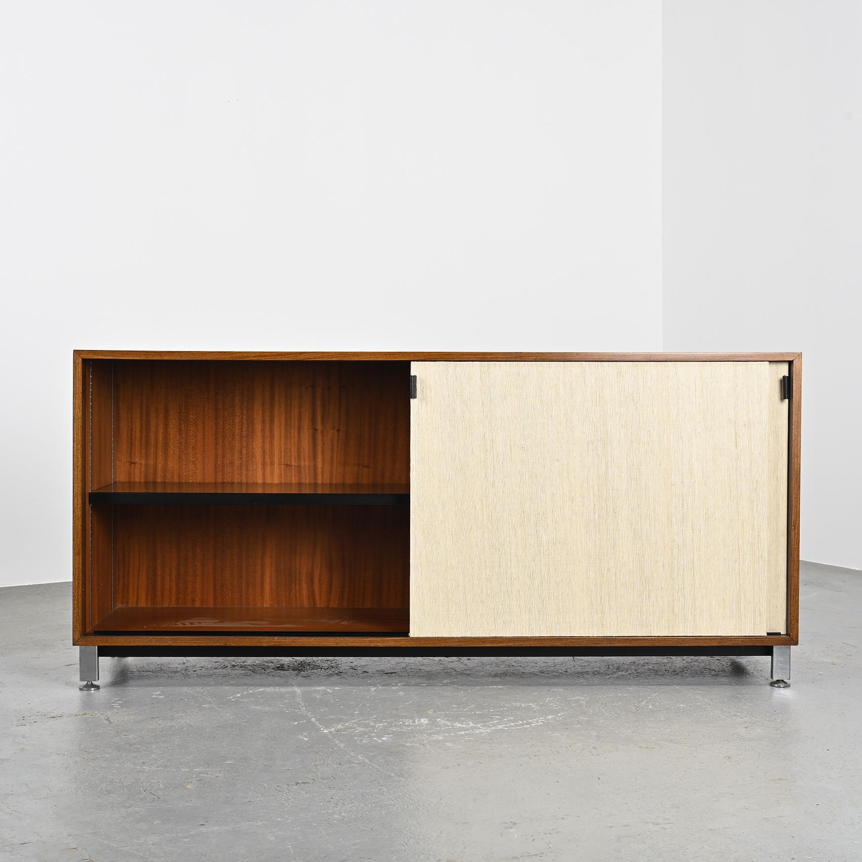 Iconic design by Florence Knoll, this sideboard has been restored with its raffia-covered doors for a natural and bohemian spirit.

The rectangular structure is made of rosewood veneer and opens with two sliding doors with fawn leather handles and