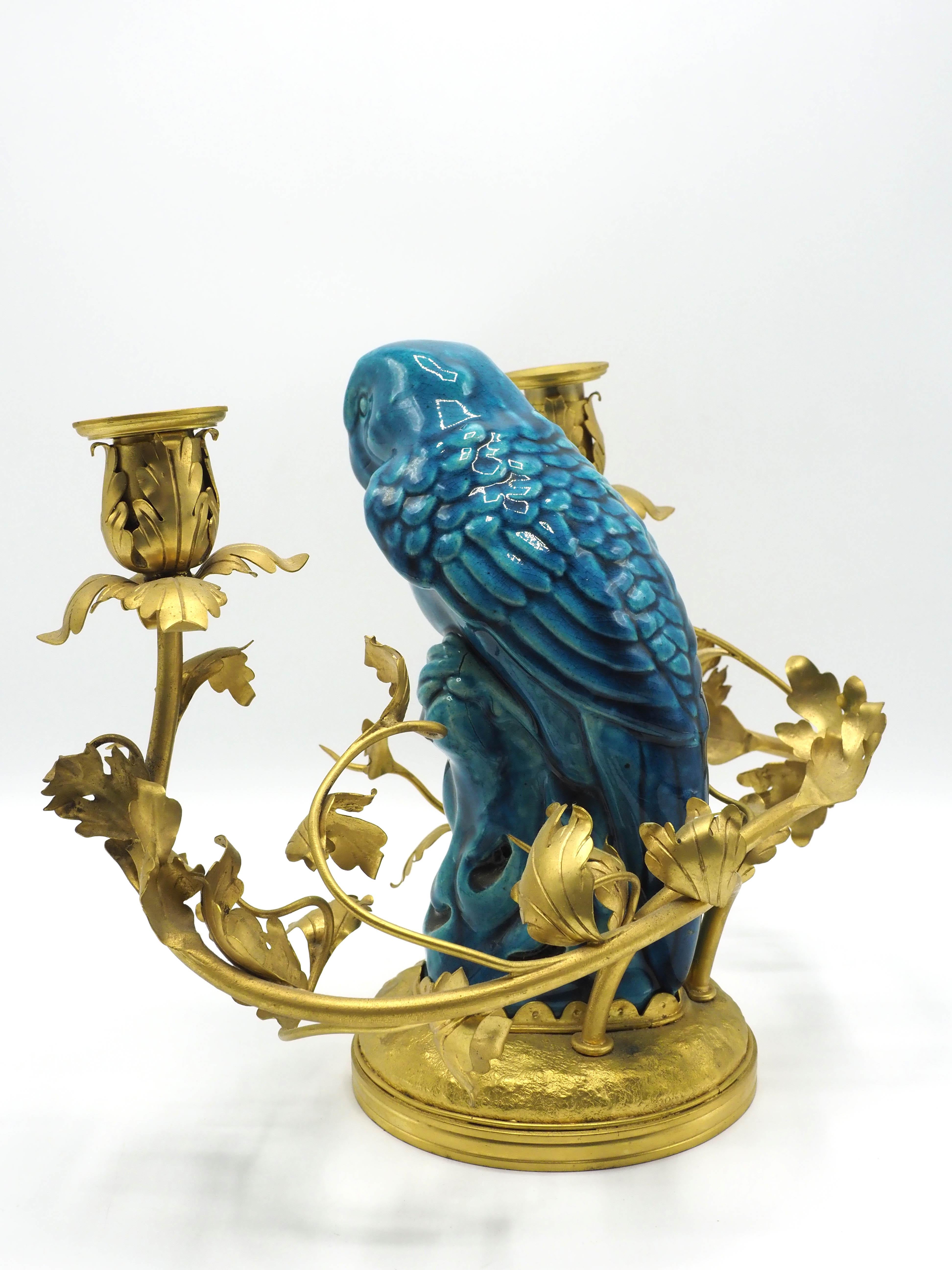 Original 20th-century Chinese chandelier in gilded bronze and blue porcelain.

Produced during the 20th century, this original Chinese chandelier has 2 components: the flower-shaped main structure is made of gilded bronze, while the parrot-shaped