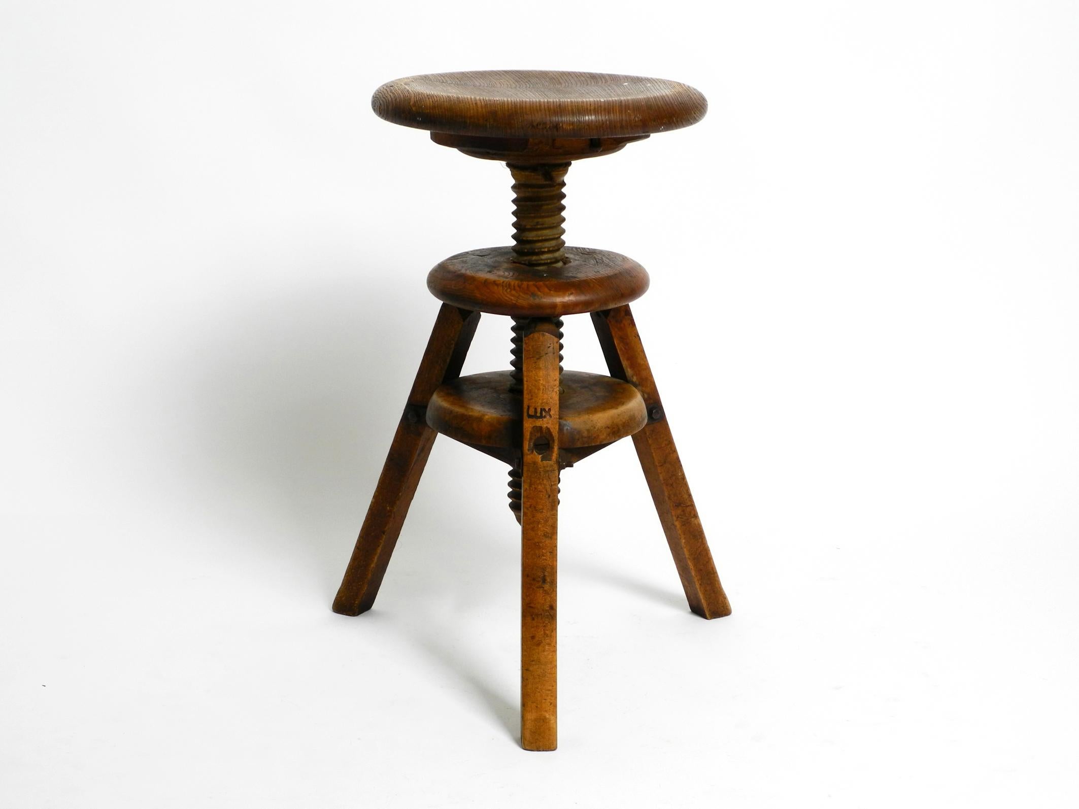 Original 30s French industrial swivel stool made of heavy oak 4