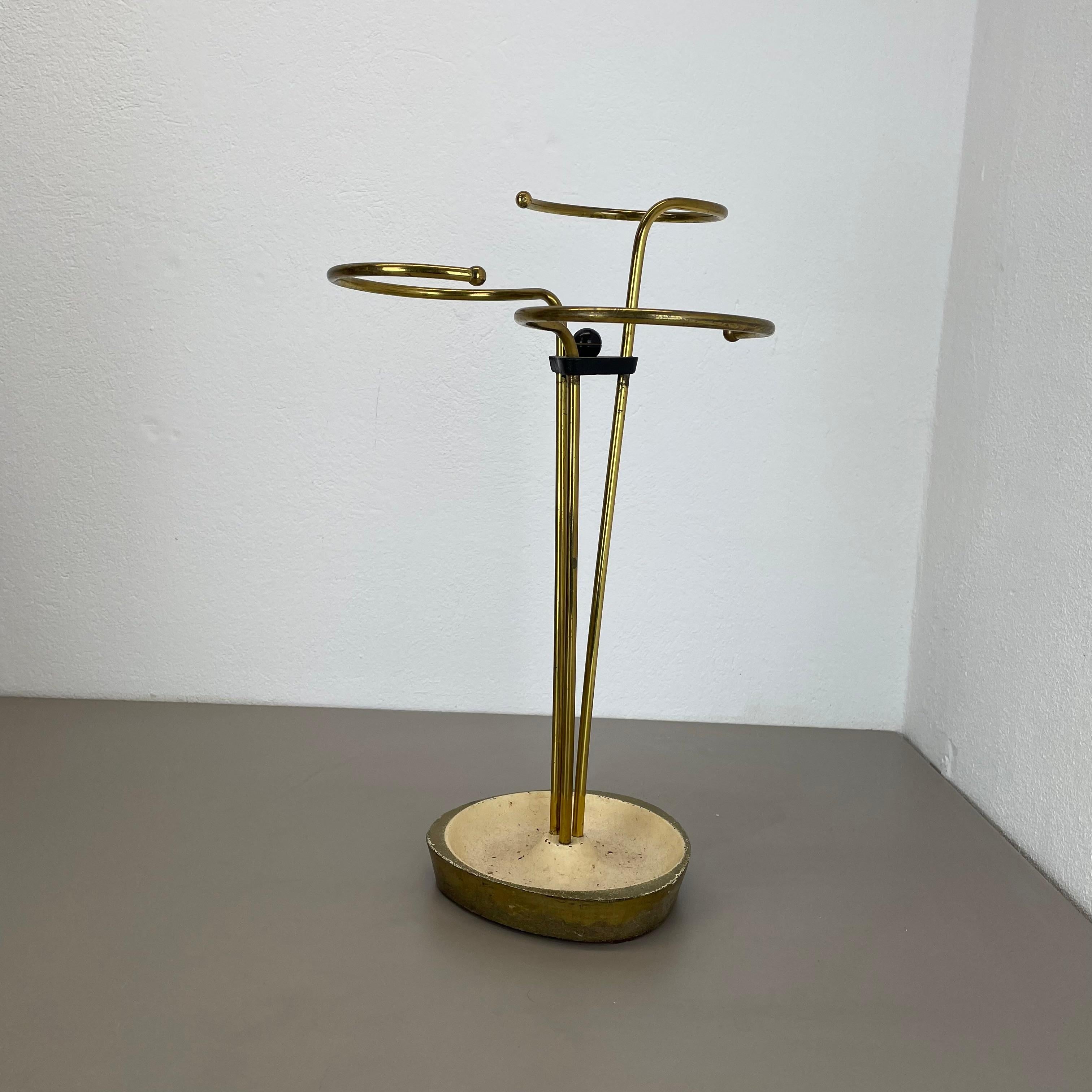 Article:

Bauhaus umbrella stand


Origin:

Germany


Age:

1950s


This original vintage Bauhaus style umbrella stand was produced in the 1950s in Germany. The umbrella holding element on the top are made of solid brass in a nice looped form, the