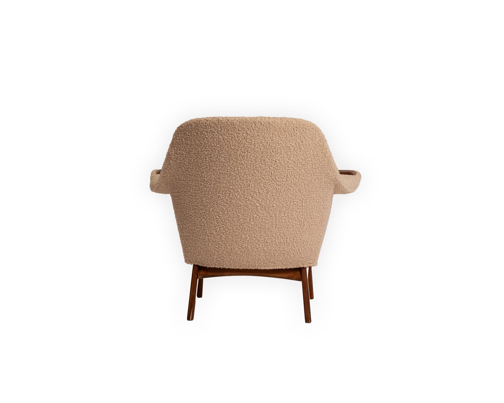 This exquisite Adrian Pearsall wingback armchair has been thoughtfully restored to honor its iconic mid-century roots while introducing a fresh sense of modern luxury. Reupholstered in a sumptuous cream bouclé, the textured fabric adds warmth and