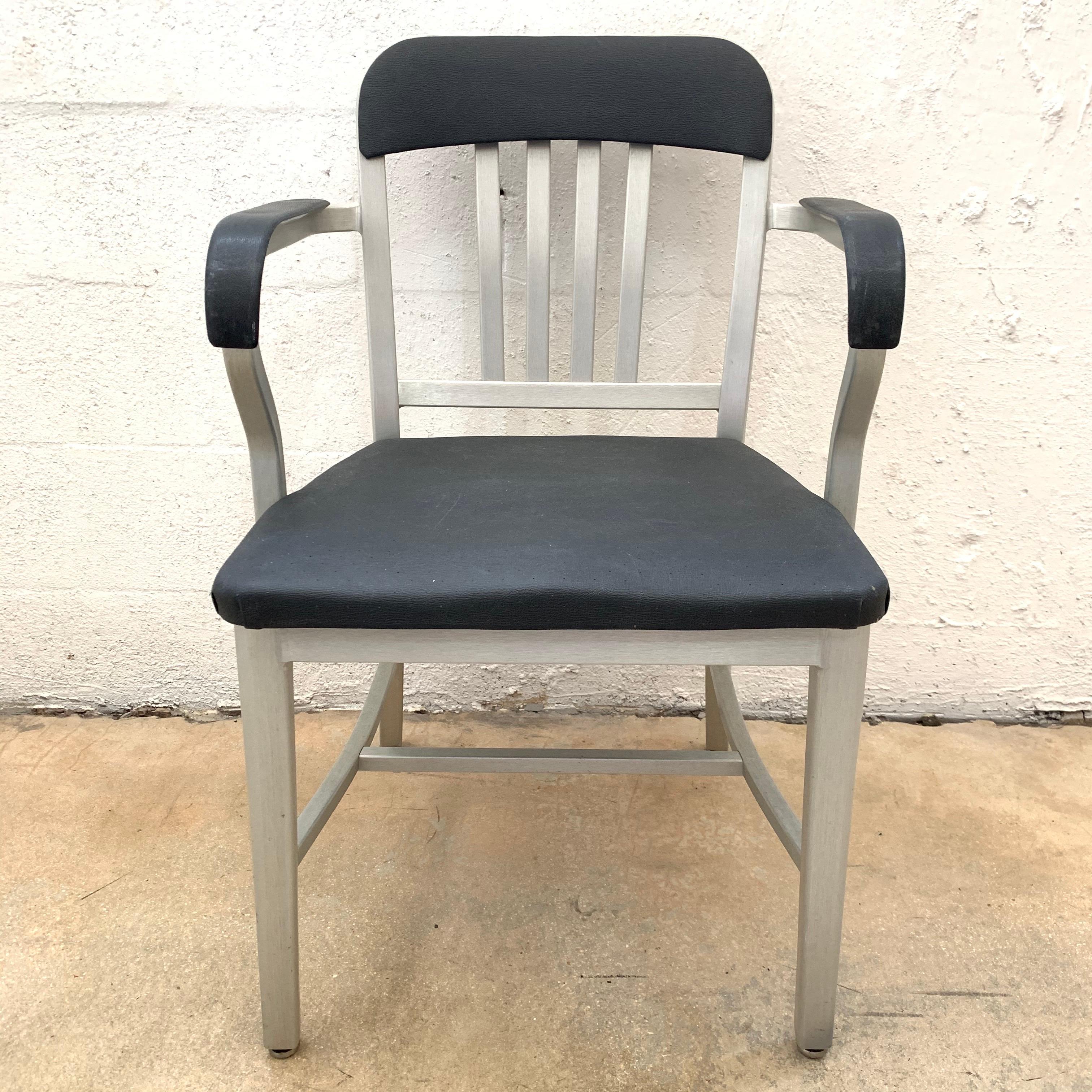 Vintage navy chair rendered in aluminum frame and original perforated vinyl upholstery by Emeco, original contract piece for the Federal government Navy.
