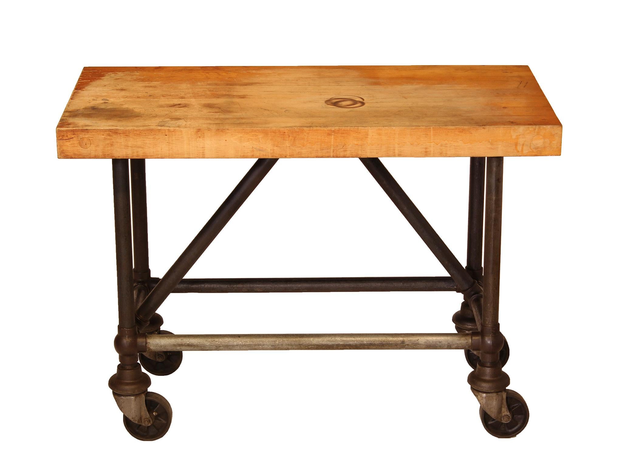Heavy duty butcher block / bar cart made with industrial cast iron pipe legs, and unique round joints with industrial casters. Overall in great condition with some wear. Dimensions: Overall width 48
