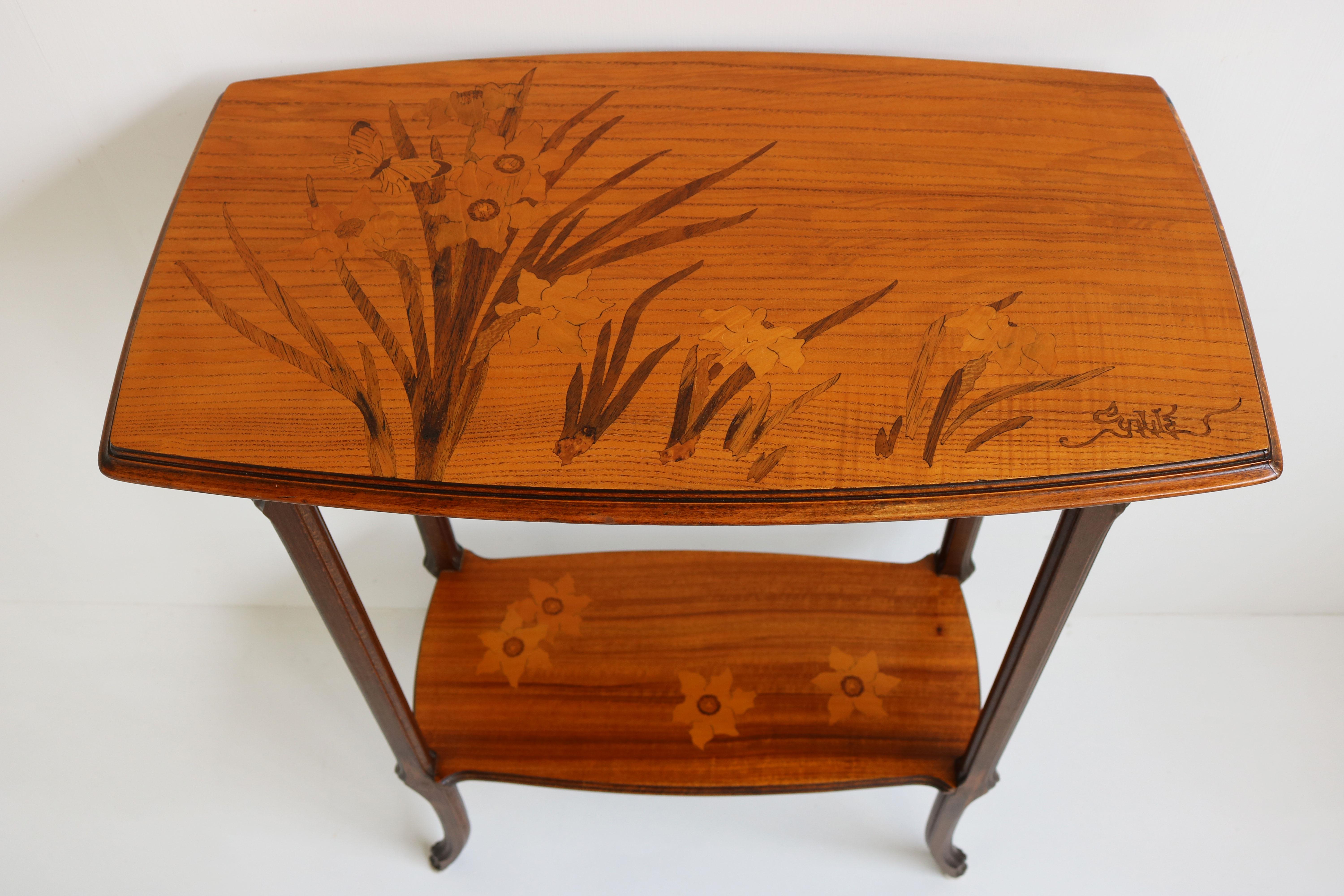Exquisite French antique Art Nouveau side table by world famous Emile Gallé made in 1900 , singed on top. Fully original antique.
Marvelous art nouveau shaped frame with 2 inlay shelves the top consists of various flowers & a stunning butterfly.
