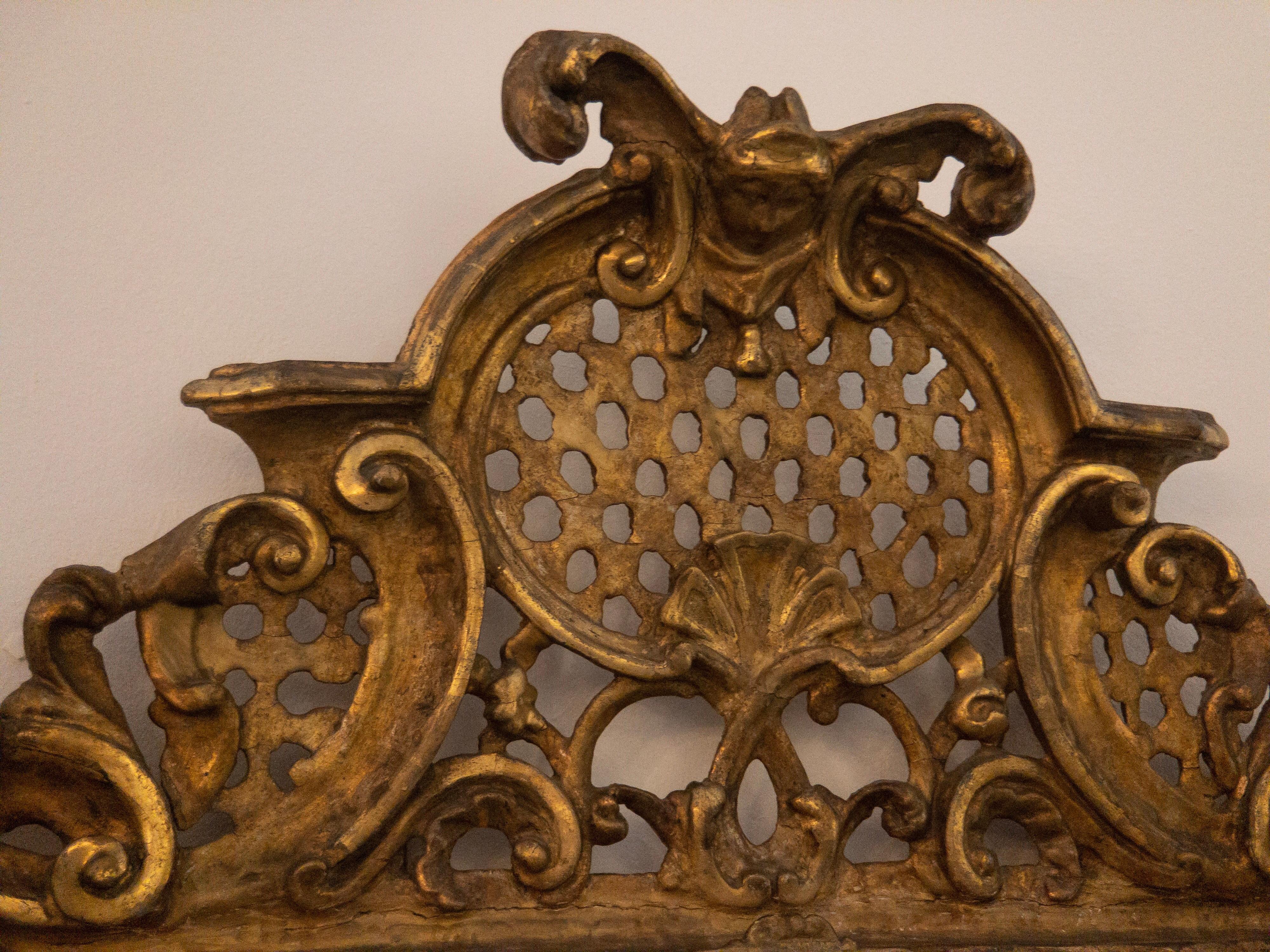 Beautiful antique Baroque wall mirror from the 18th century. The original Baroque wall mirror has wonderful gilded ornaments made of plaster. As you can see at the pictures the gold plating is very thick and has a stunning Patina, which only was