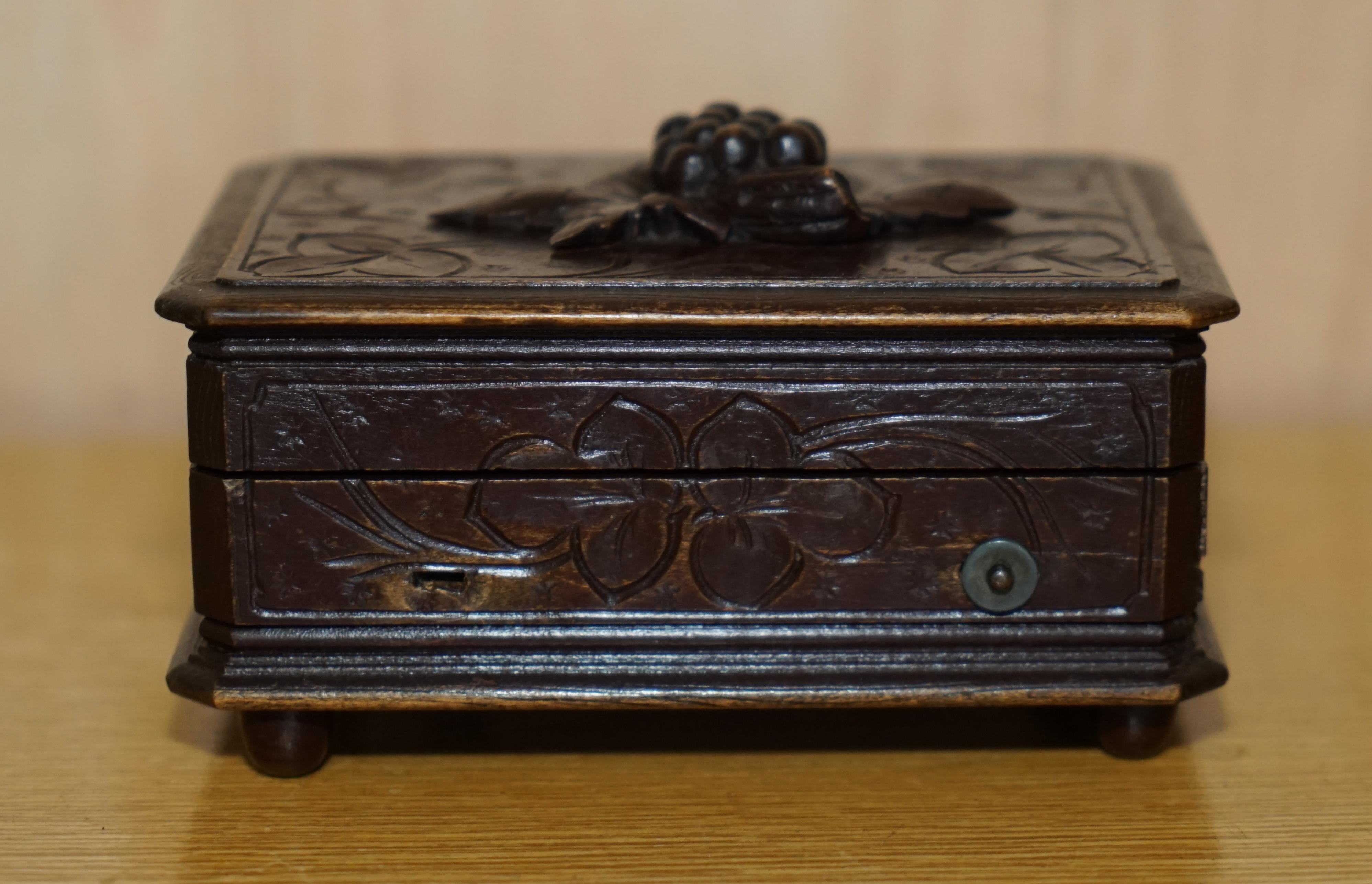 We are delighted to offer for sale this antique original circa 1880 Black Forest Wood music box with grape vine carving to the top

A very good looking and well made piece, it is hand carved all over with floral decorations to the top

The