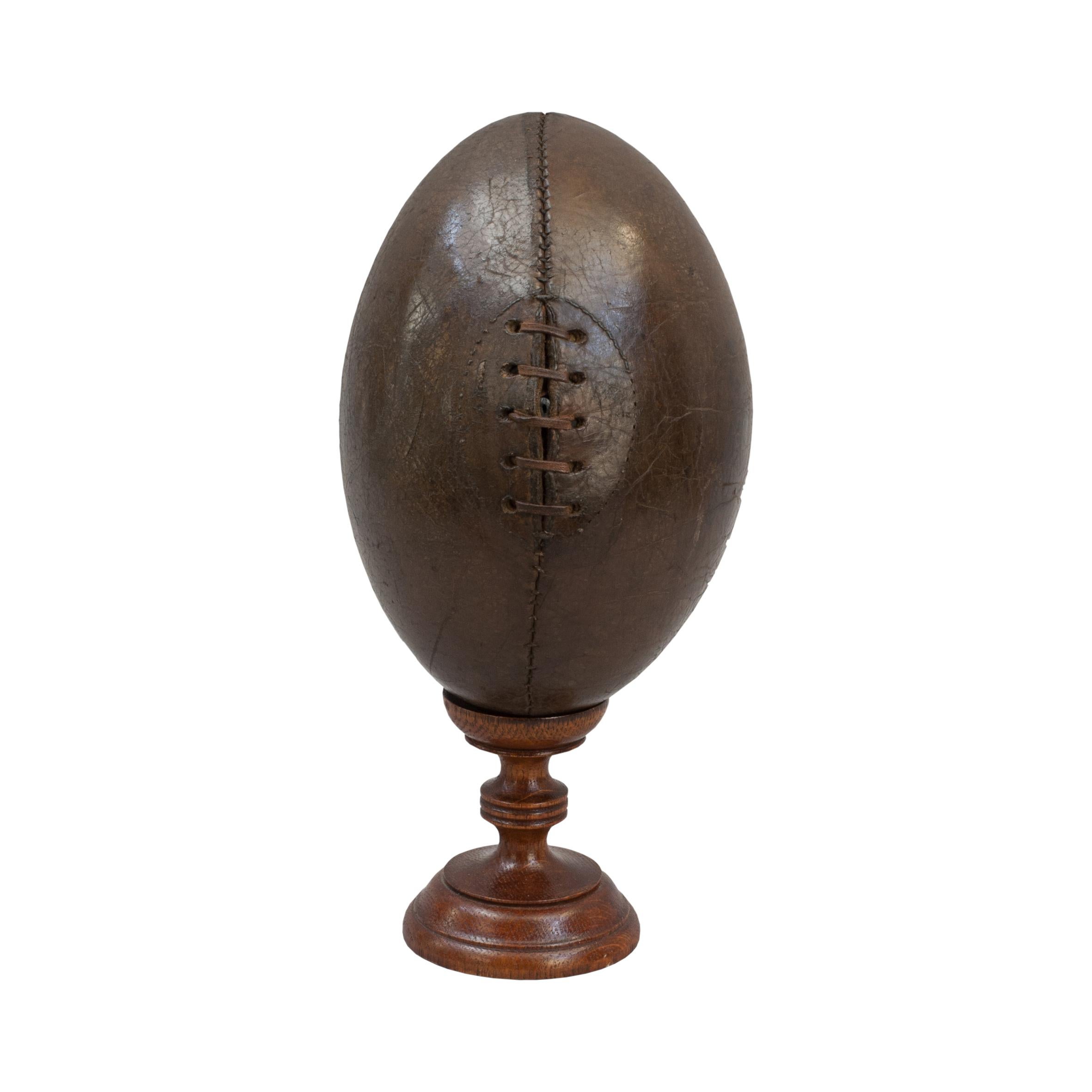Original Antique Leather Rugby Ball.
A beautiful leather rugby ball made with the traditional four leather panels with good dark colour and patina. The ball has a lace-up slit to the front that would have enabled bladder inflation, there is an