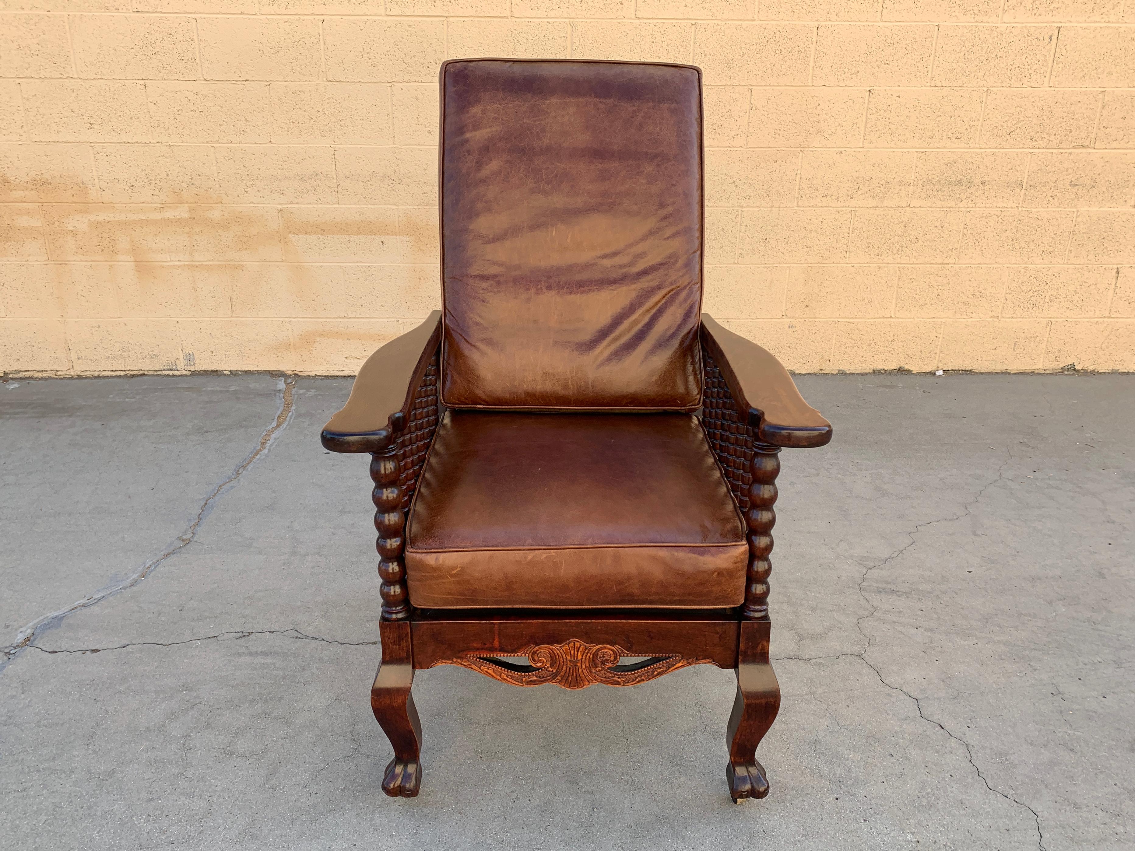 Original Morris reclining armchair, circa 1910s. This chair is a beautiful example of Victorian craftsman styling with many carved spindles, brass hardware and claw feet. Fully reclines and rolls on original casters. Reconditioned cherry stained oak