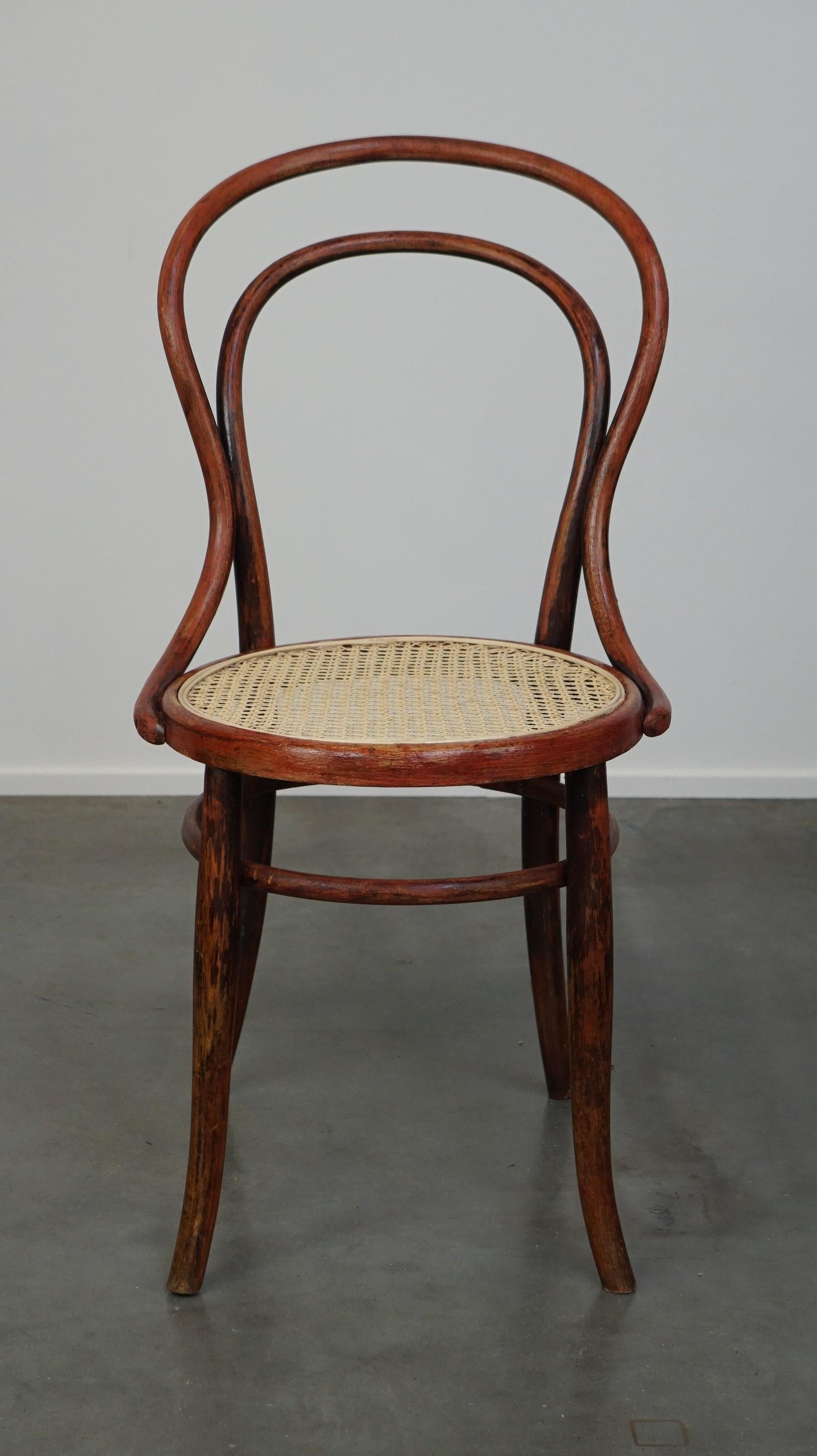 Chair no. 14, also known as a bistro chair, designed by Thonet, produced by Fischel, was one of Thonet's most popular chairs alongside chair no. 18. It features a half arch in the backrest and was likely produced around 1900. This model is still