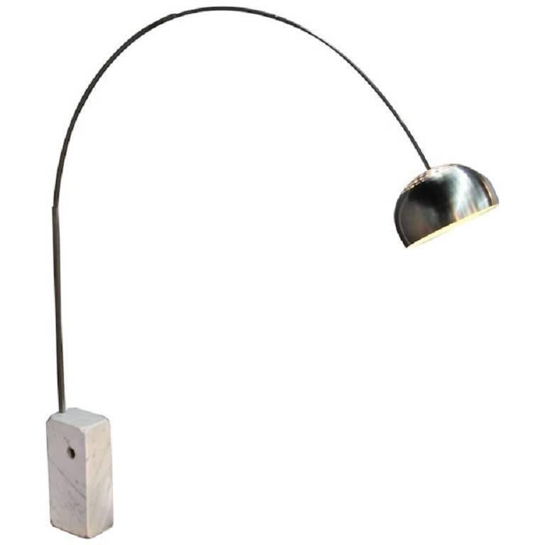 The brothers Castiglioni designed their iconic Arco lamp in 1962 to cast light far from a power source. Its marble base is so heavy it was made with a hole where a broom handle could be inserted to help lift it. This example is an original, not a
