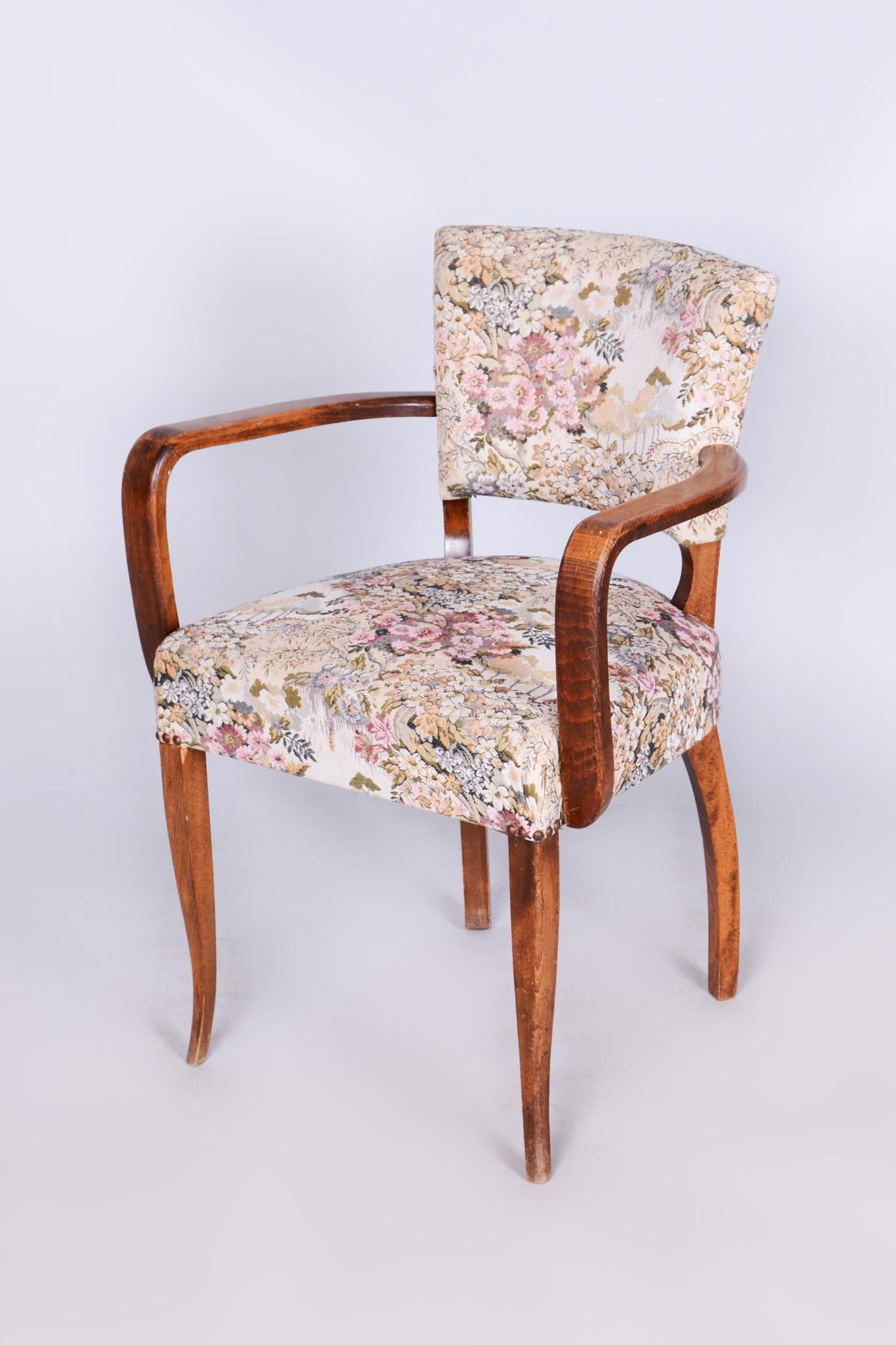 This elegant Art Deco armchair, designed by Jules Leleu, comes from France from the first half of the 20th century. It is made of stained beech and has undergone careful restoration. During the restoration, the original polish was revived. The