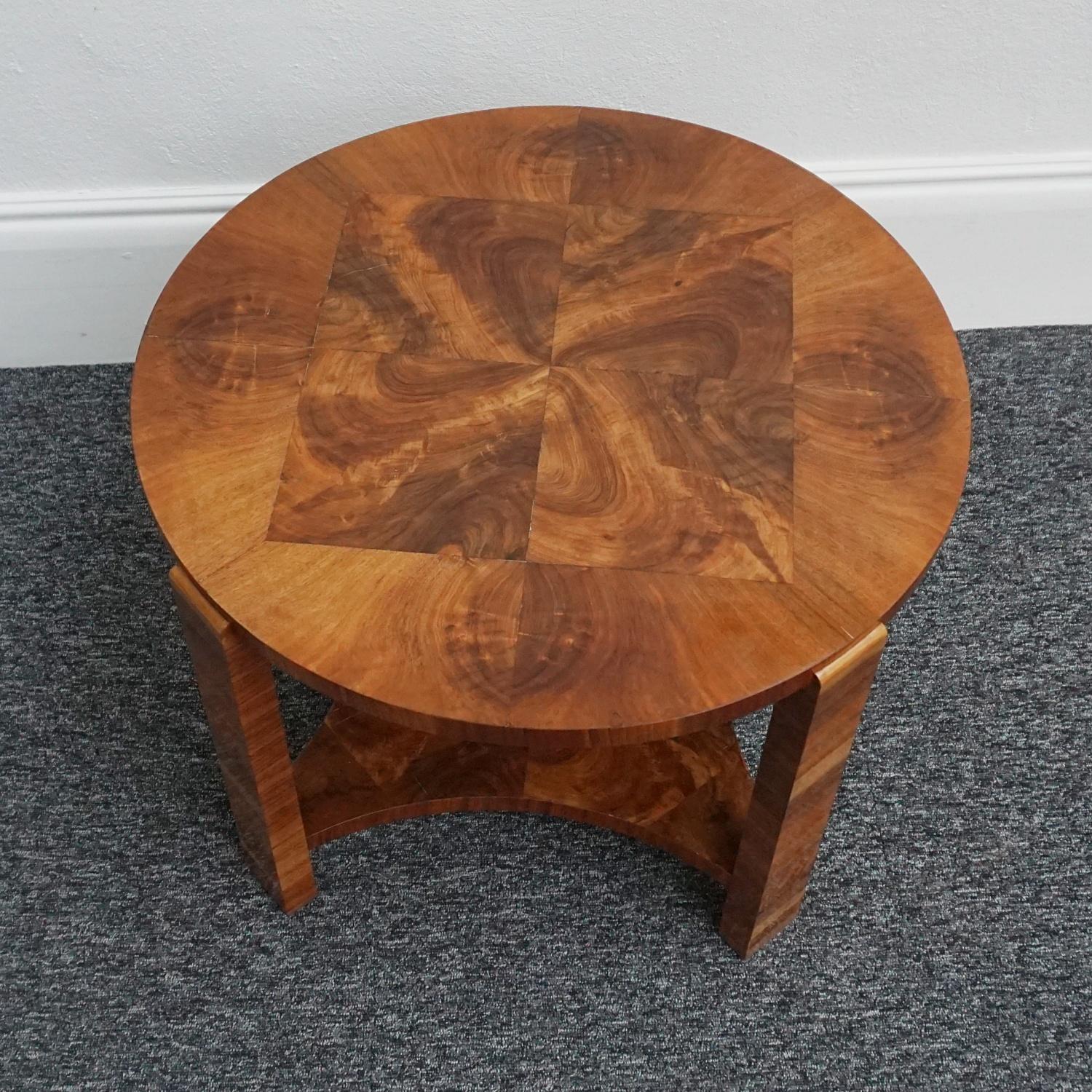 An Art Deco side table. Circular side table with squared burr walnut centre and burr walnut surround. Figured walnut legs and a burr walnut shaped lower shelf. 

Dimensions: H 51cm D 67cm 

Origin: English

Date: Circa 1935 

Item Number:
