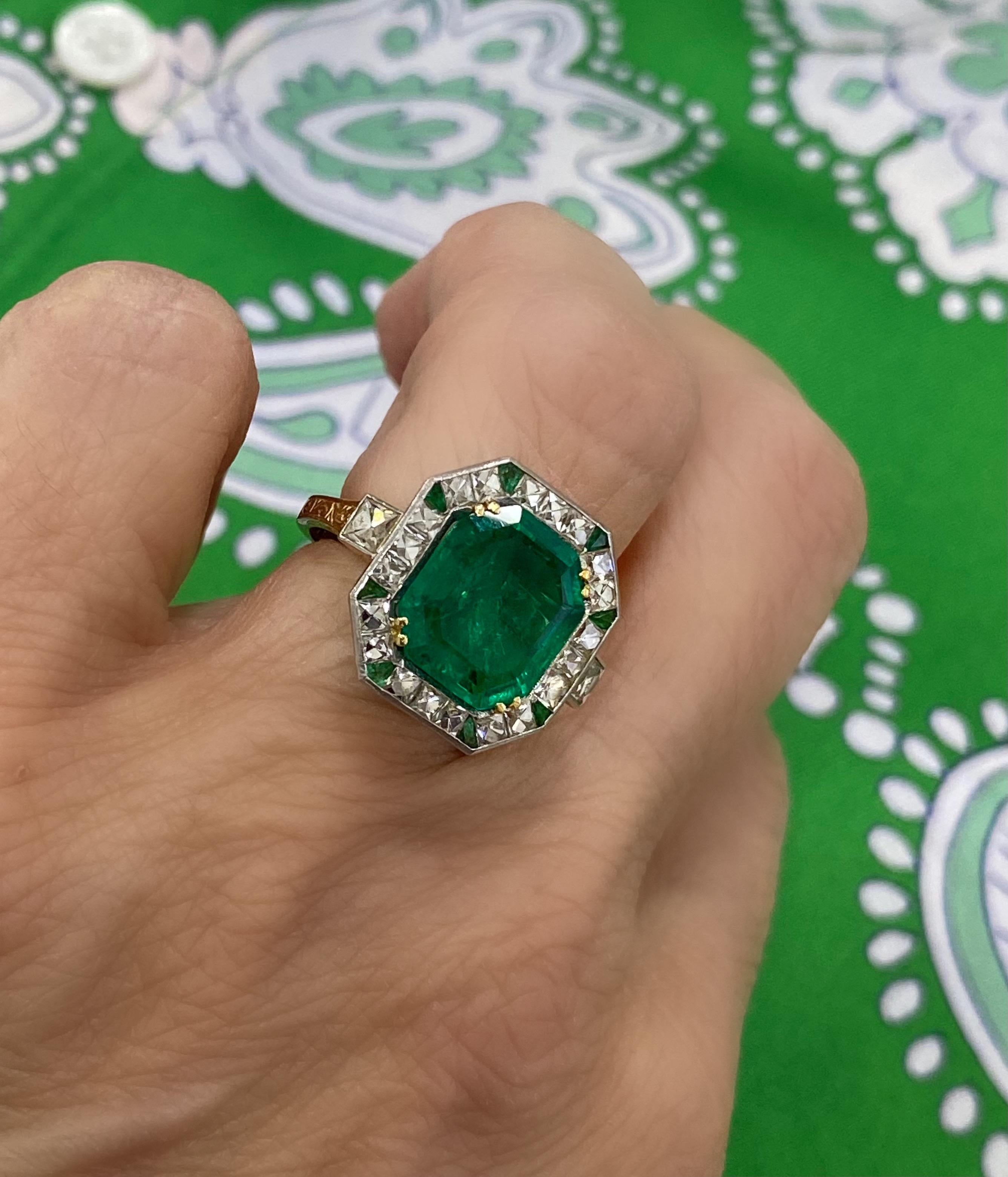 This is an incredible example of Circa 1920s Art Deco design and style at its best! This handmade 18k gold and platinum top ring features a natural emerald cut 3.60 carat Colombian Emerald (11.16x9.90x4.56), with the GAL report attached. This