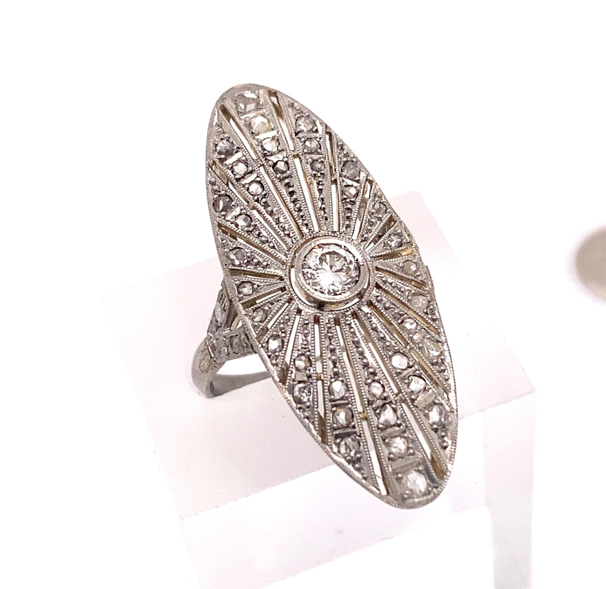 This is a beautiful original art deco filigree ring set with a .30 cart transitional cut with 42 rose cut diamonds. The setting is marked 950 for platinum has detailed filigree on the gallery. The center diamond is I color VS-2 clarity total diamond