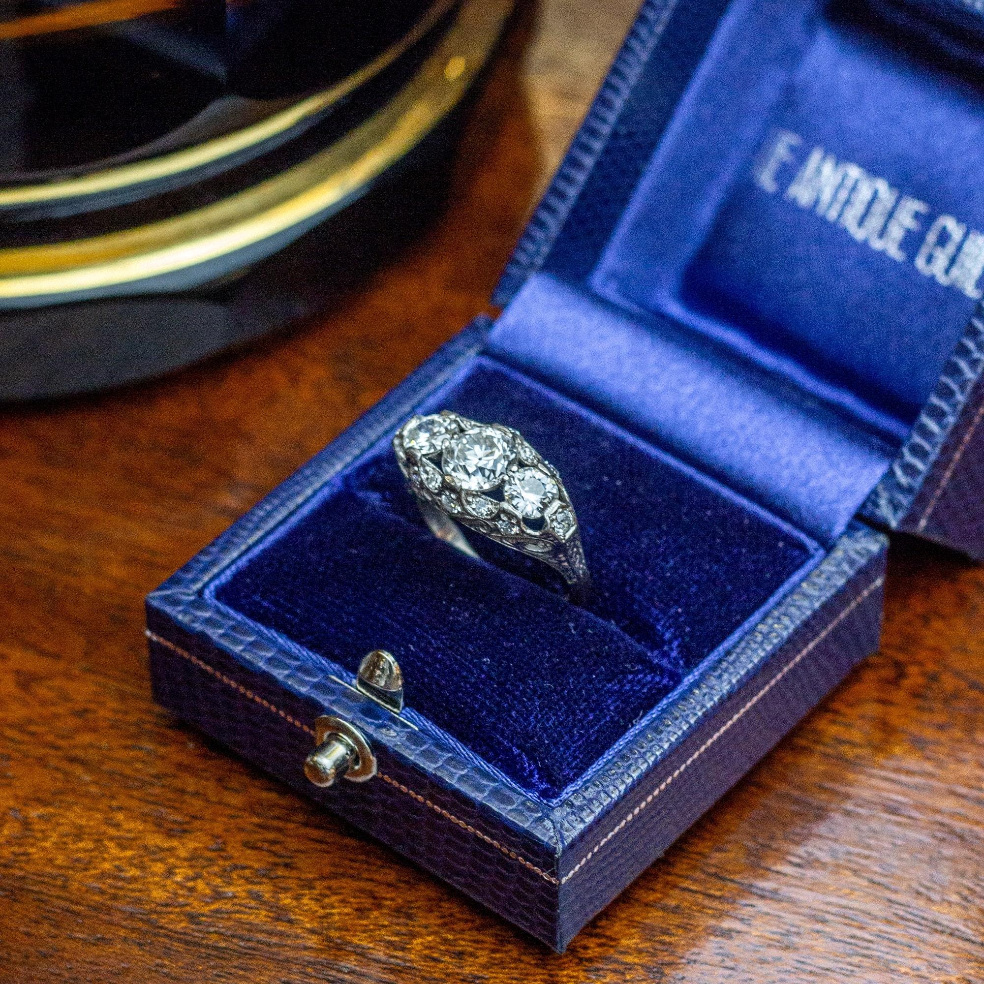 An exceptional Art Deco, platinum and white gold ring set with diamonds. This ring is set with fine quality 'Old European Cut' diamonds which are placed in a beautifully engraved and scalloped gallery. The central diamond is of G colour and VS2