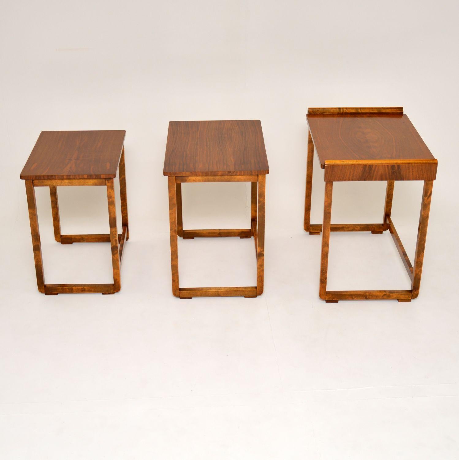 A stunning original Art Deco period nest of tables in walnut. These were made in England, they date from circa 1920s-1930s.

They are of amazing quality and have an unusual design. The legs are U-shaped, and the table tops have thick walnut edges.