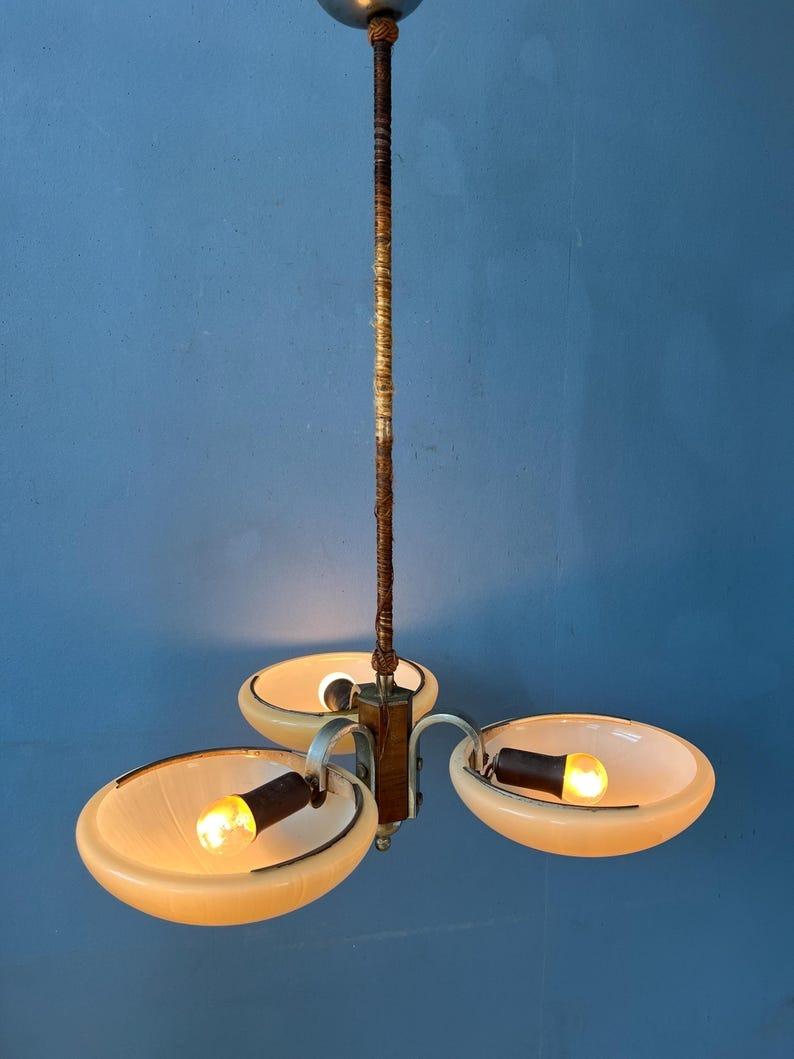 Original art deco light fixture with three glass shades. The shades are connected to a metal frame with wooden elements and rope around the pole. The lamp requires three E27/26 (standard) lightbulbs.

Additional information: 
Materials: Plastic,